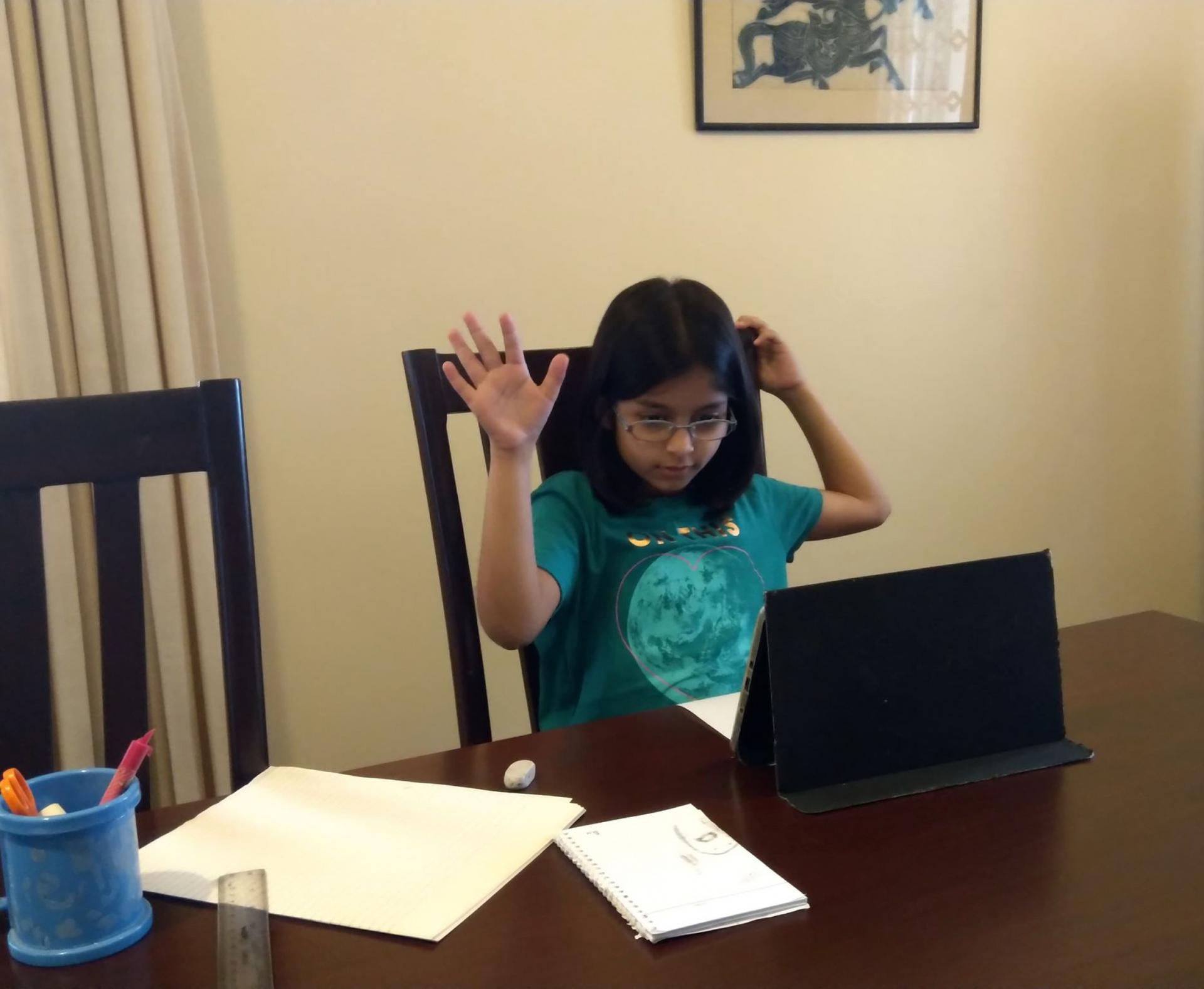 Farah Husain of Karachi, Pakistan, participates in her online school lesson from home.
