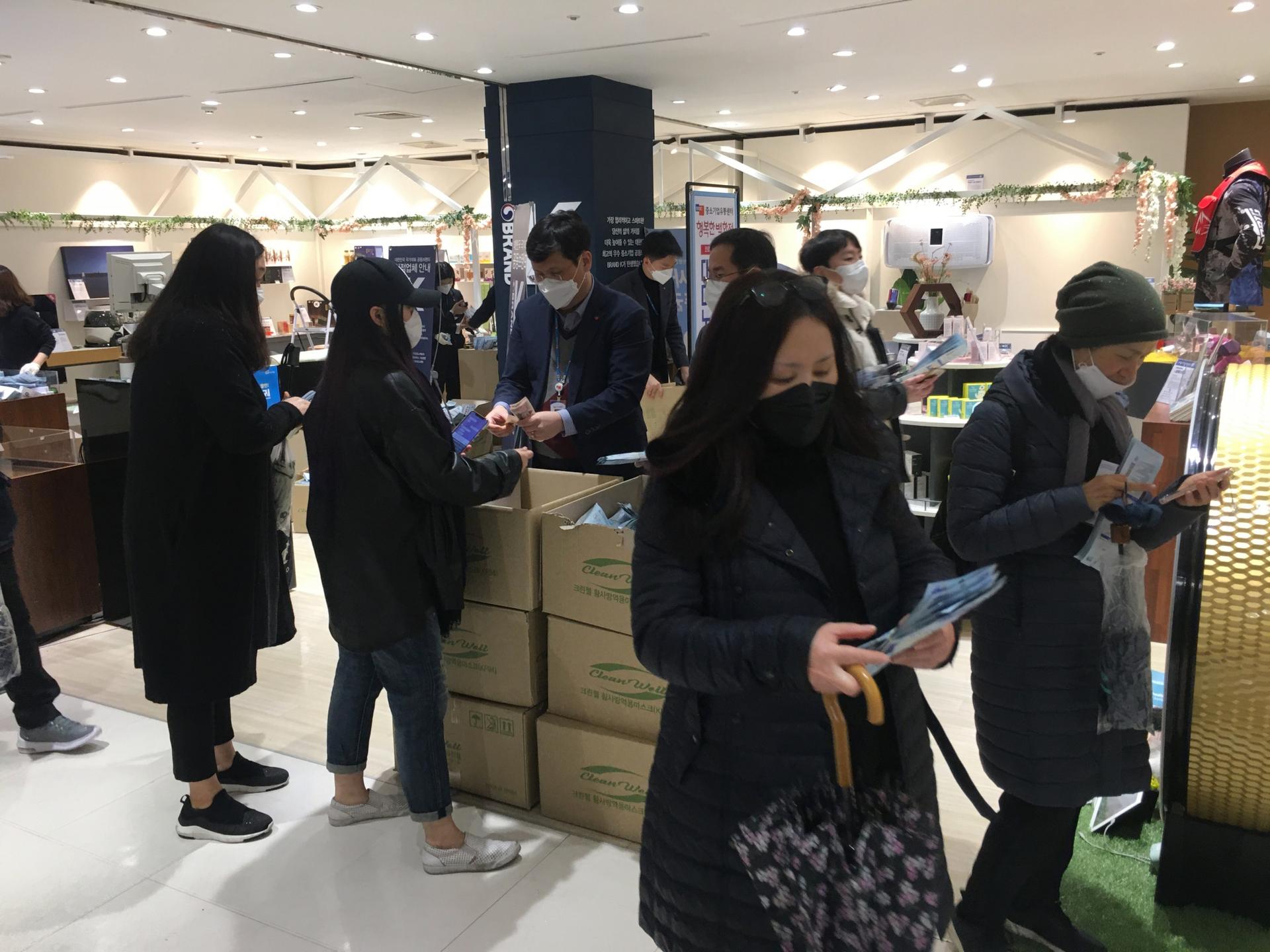 Shoppers buy subsidized respiratory masks at a department store in Seoul, South Korea. 