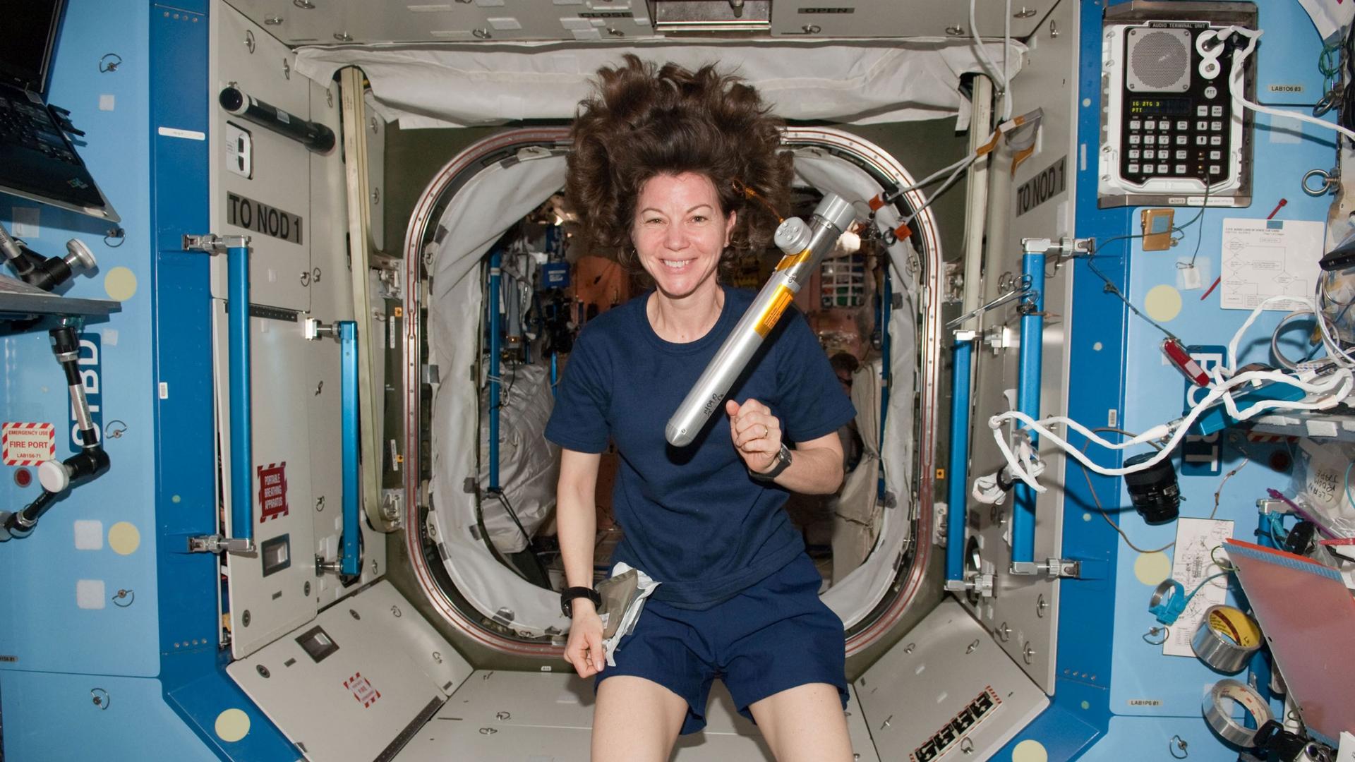A woman floats in a spacecraft