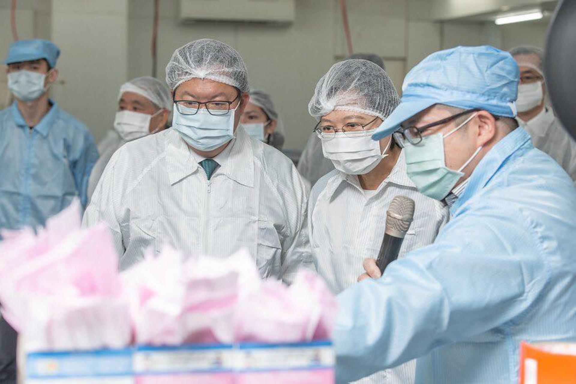 Taiwanese President Tsai Ing-wen (second from right) visited a mask manufacturing plant in Taoyuan, Taiwan, on March 9, 2020.