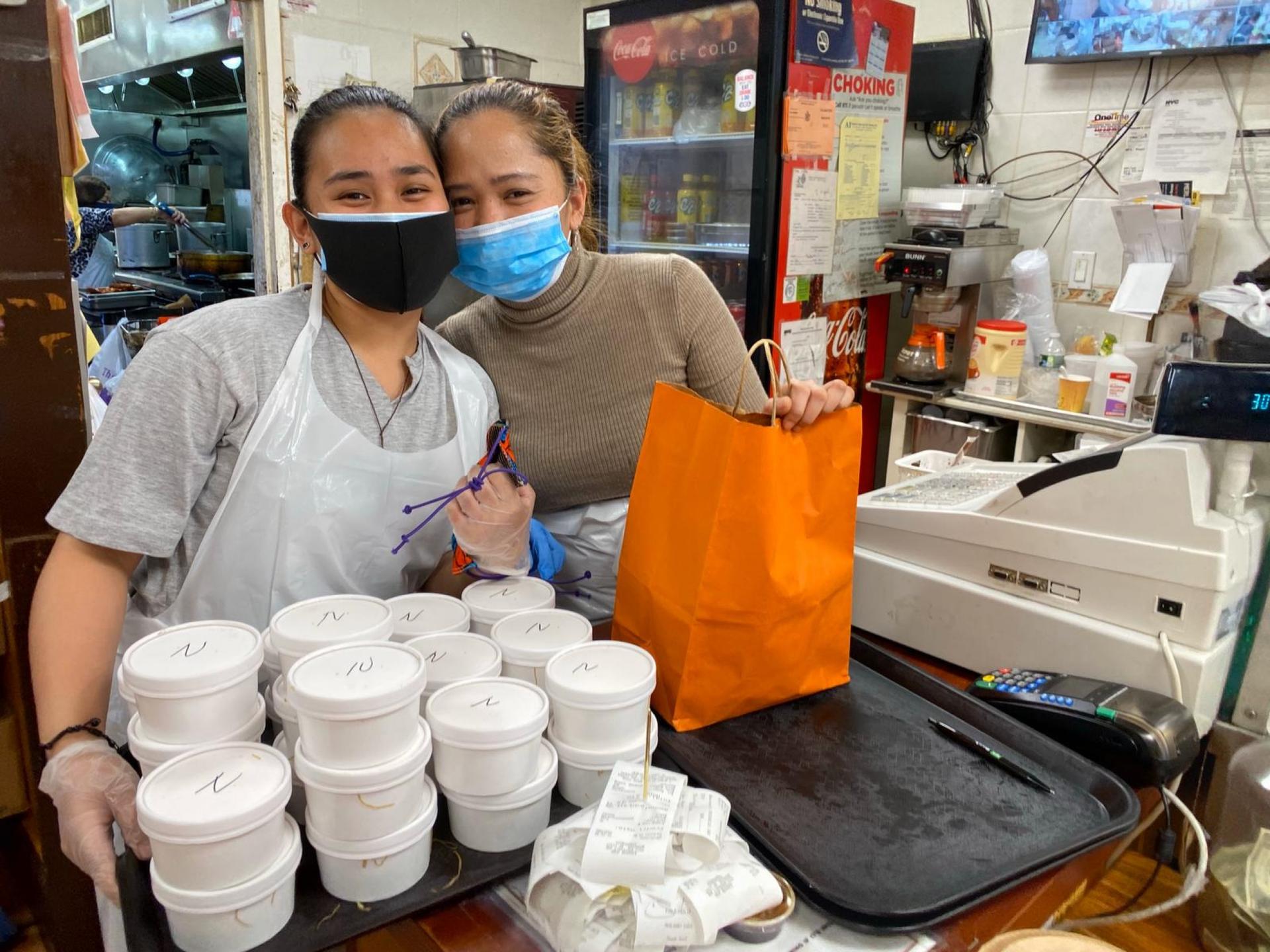 Food workers packing up meals for Filipino health workers at Kabayan restaurant in Woodside, Queens.