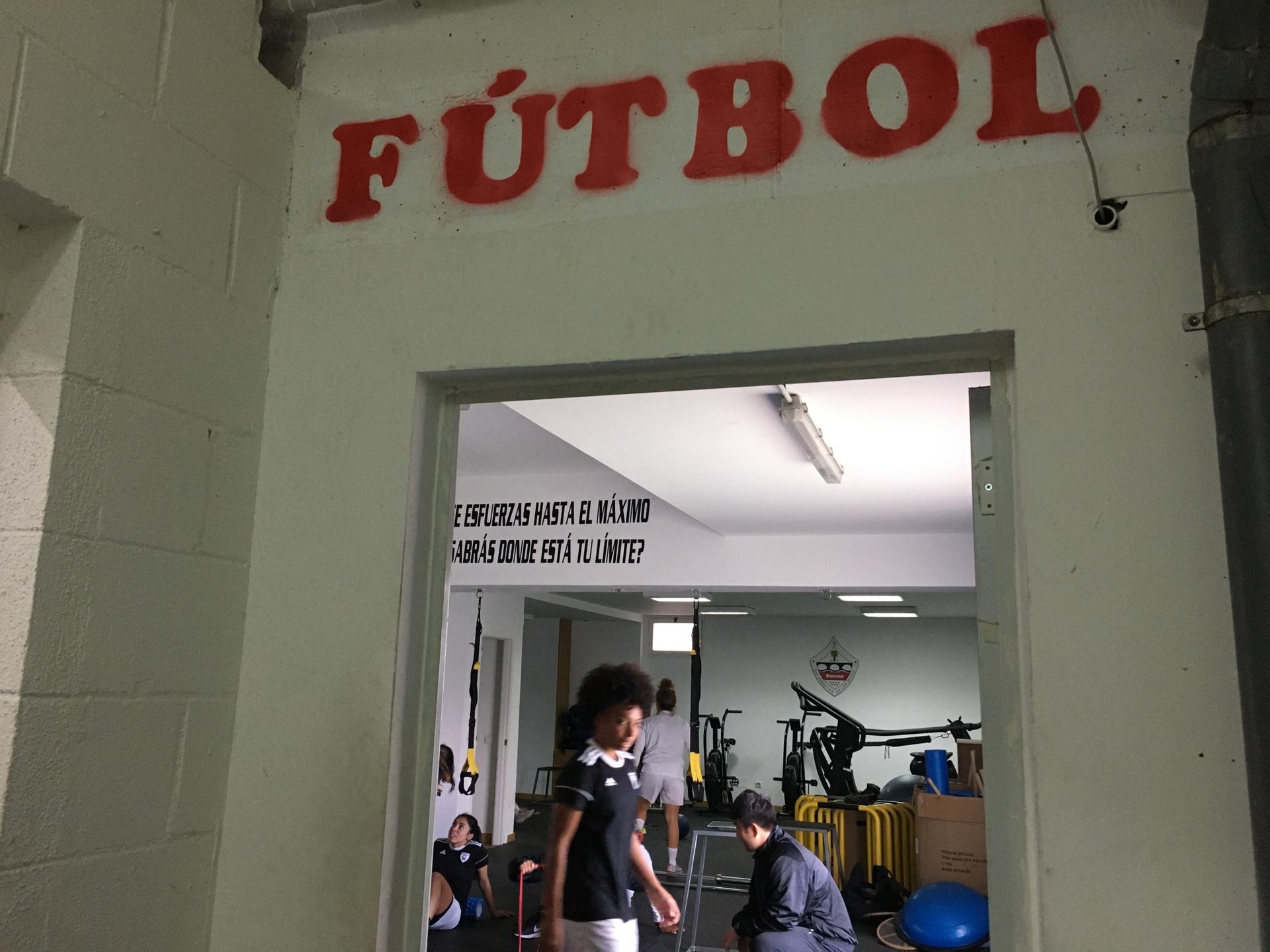 Entrance to gym reads "Futbol" in red letters. 
