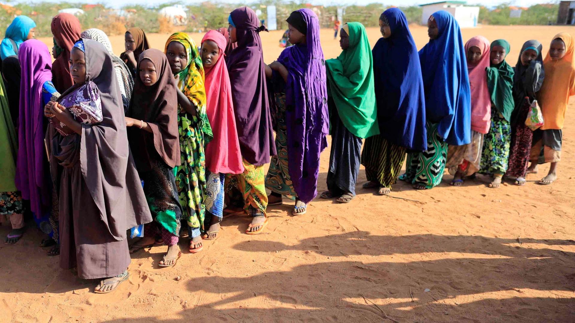 Internally displaced girls in Somalia queue before at a school beside an IDP camp in Dollow, Somalia, April 4, 2017. 