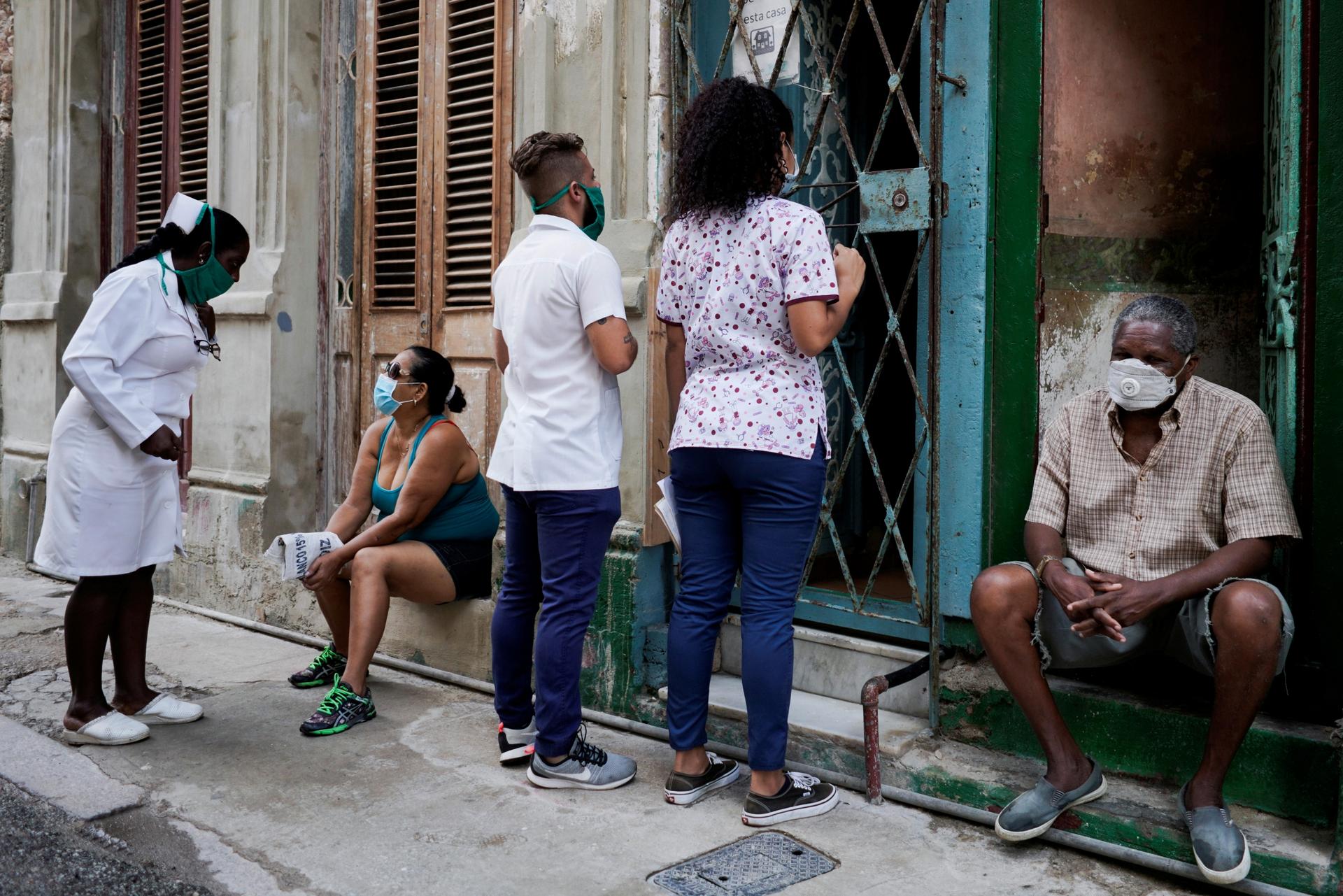Medical students check door-to-door for people with symptoms amid concerns about the spread of the coronavirus disease (COVID-19), in downtown Havana, Cuba, May 11, 2020.