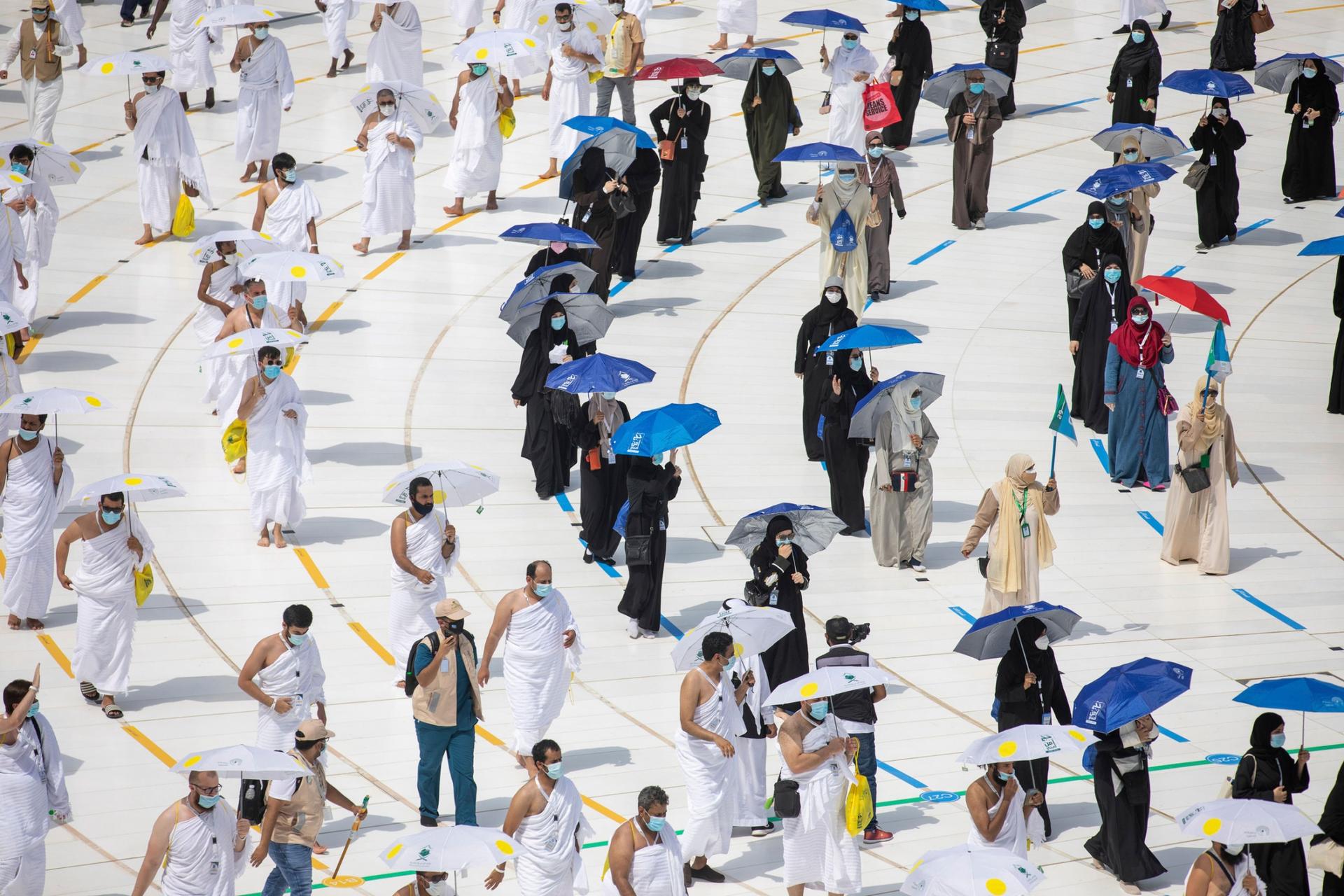 Pilgrims are shown walking on designated lines circuling the Kaaba.