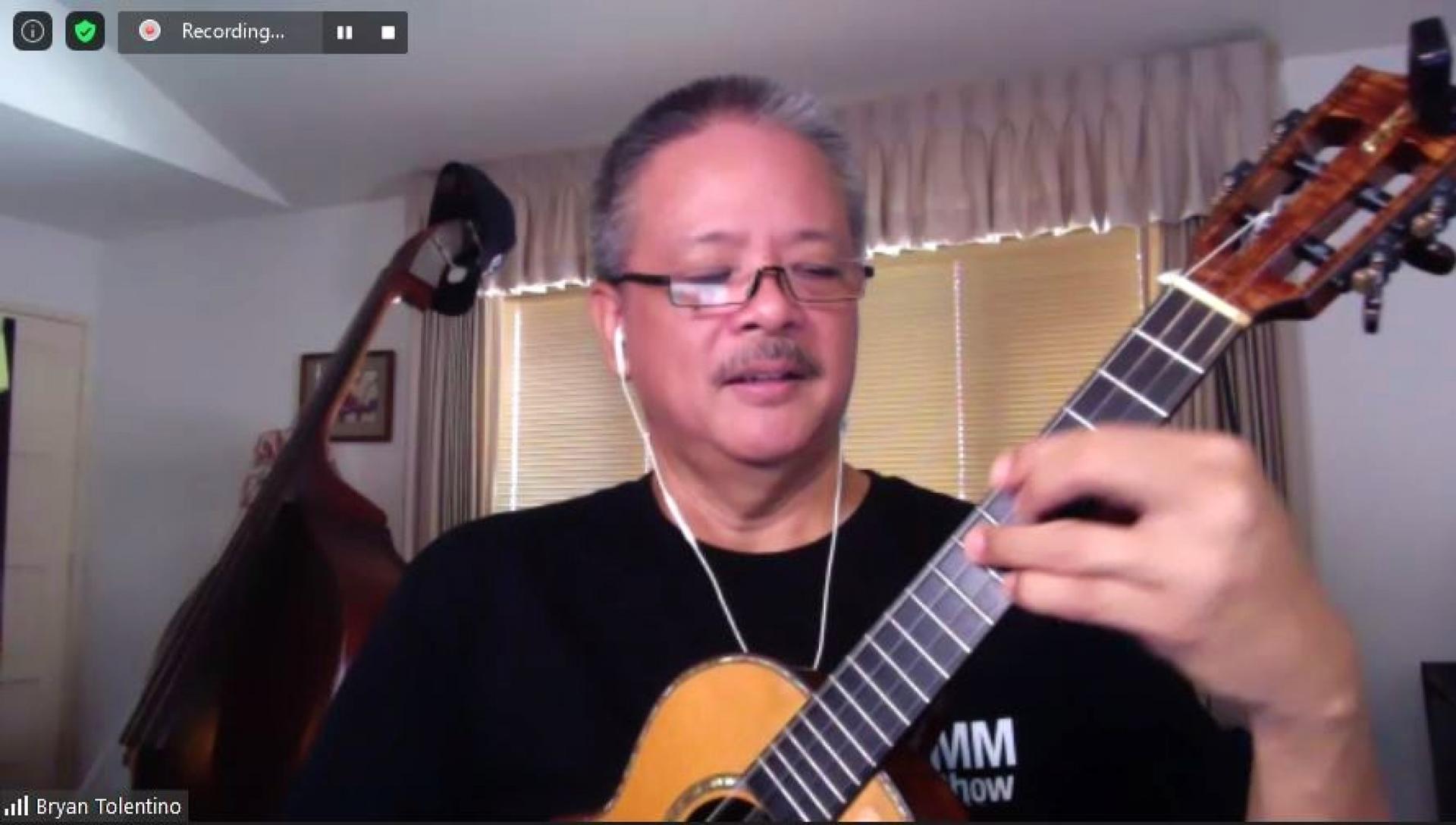 A Zoom screenshot of ukulele teacher Brian Tolentino playing “Somewhere Over the Rainbow.” 