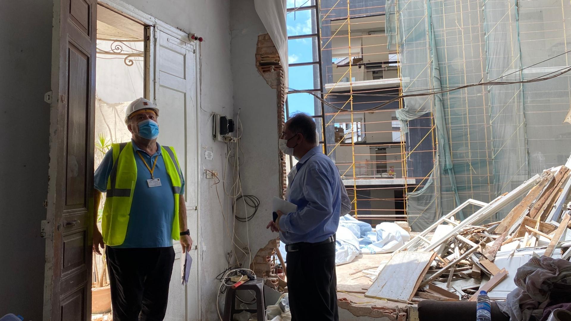 Henri's son Joseph greets an engineer who came to survey the damage at the Azar family home in Beirut's Mar Mikhaël district. 