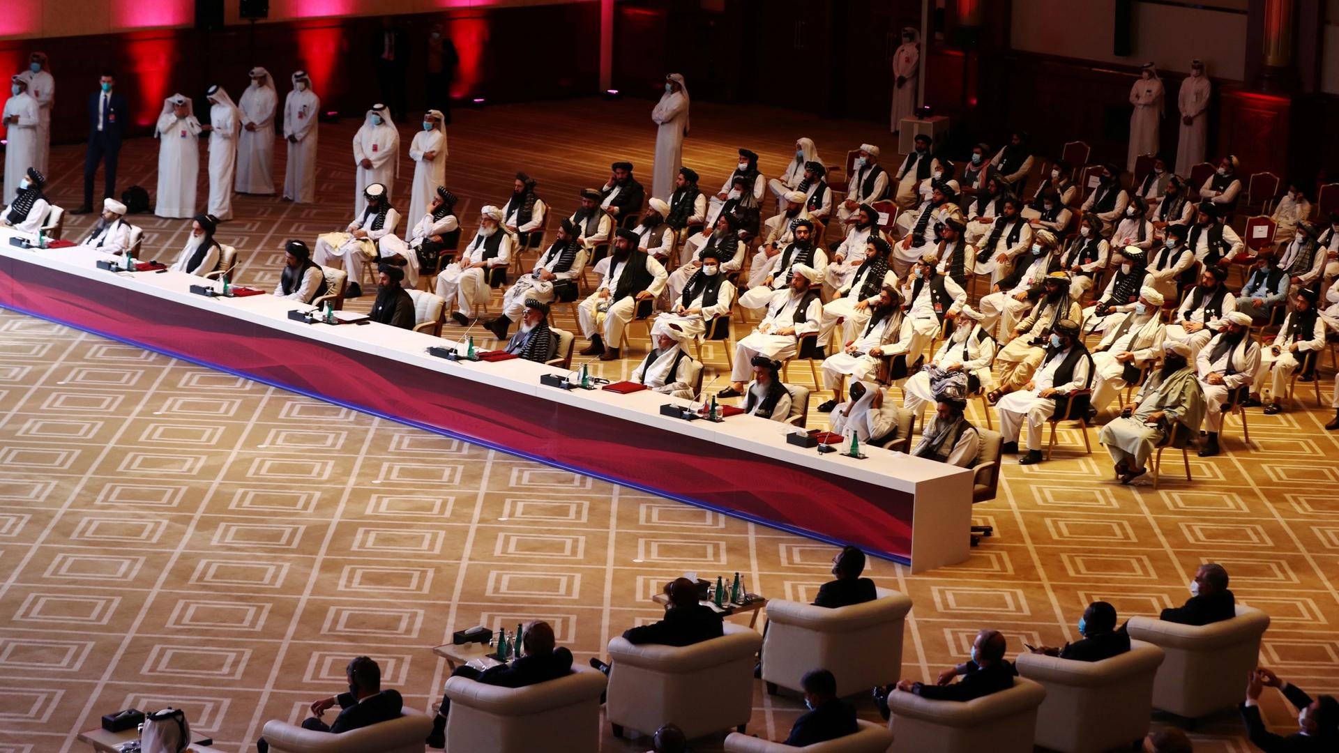 Delegates attend talks between the Afghan government and Taliban insurgents in Doha, Qatar, Sept. 12, 2020. 