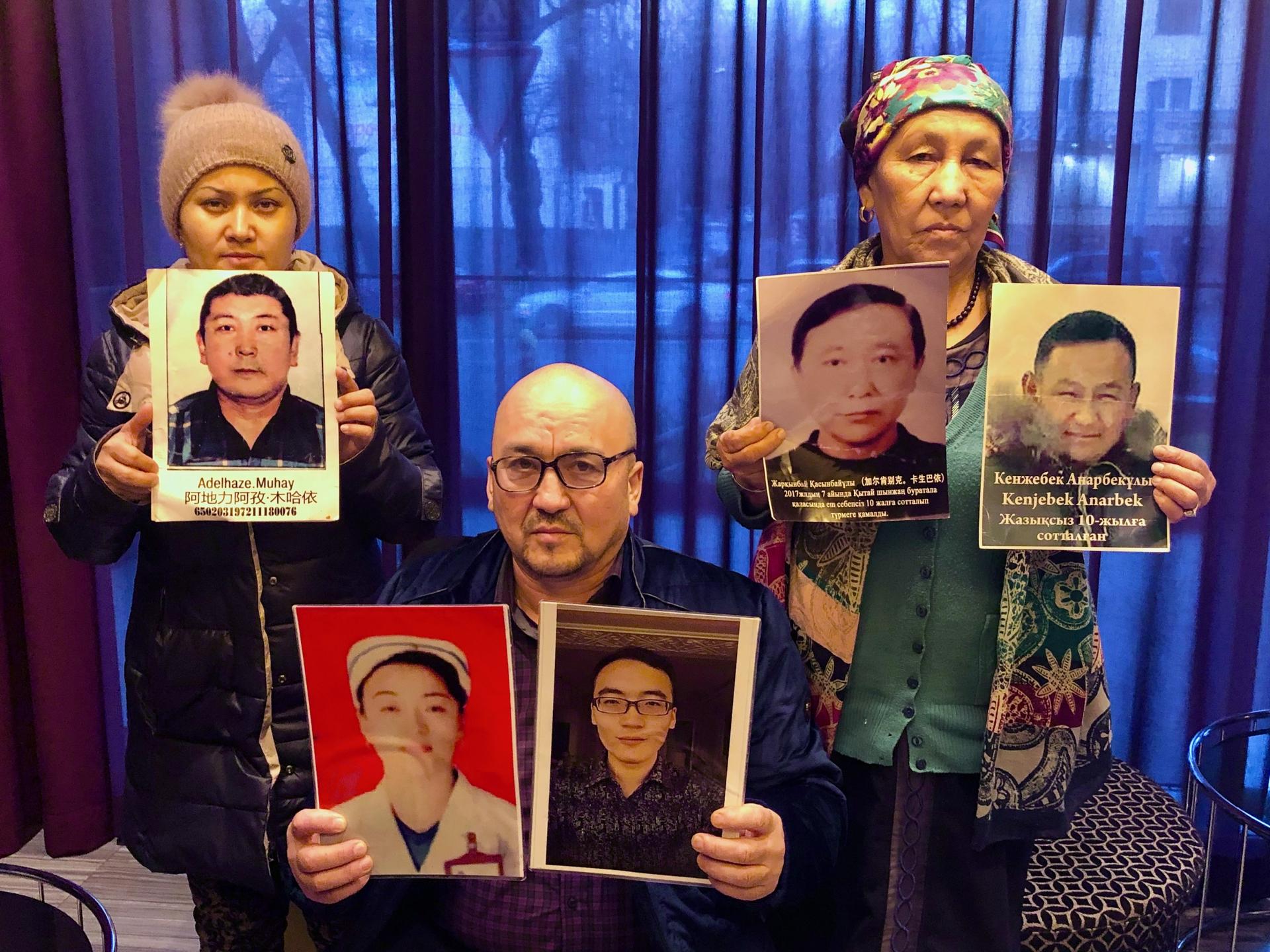 Kazakhs in Almaty hold up photos of their relatives being held in detention in Xinjiang, China.