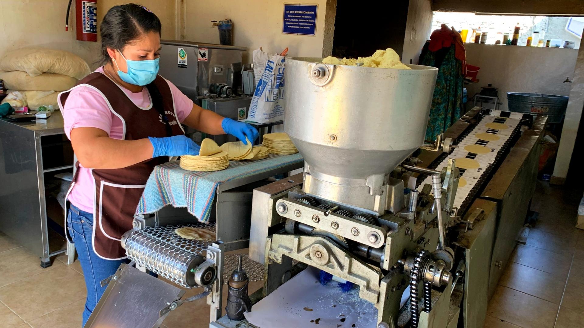 Marta Hernandez stacks tortillas coming out of the oven at La Abuela.