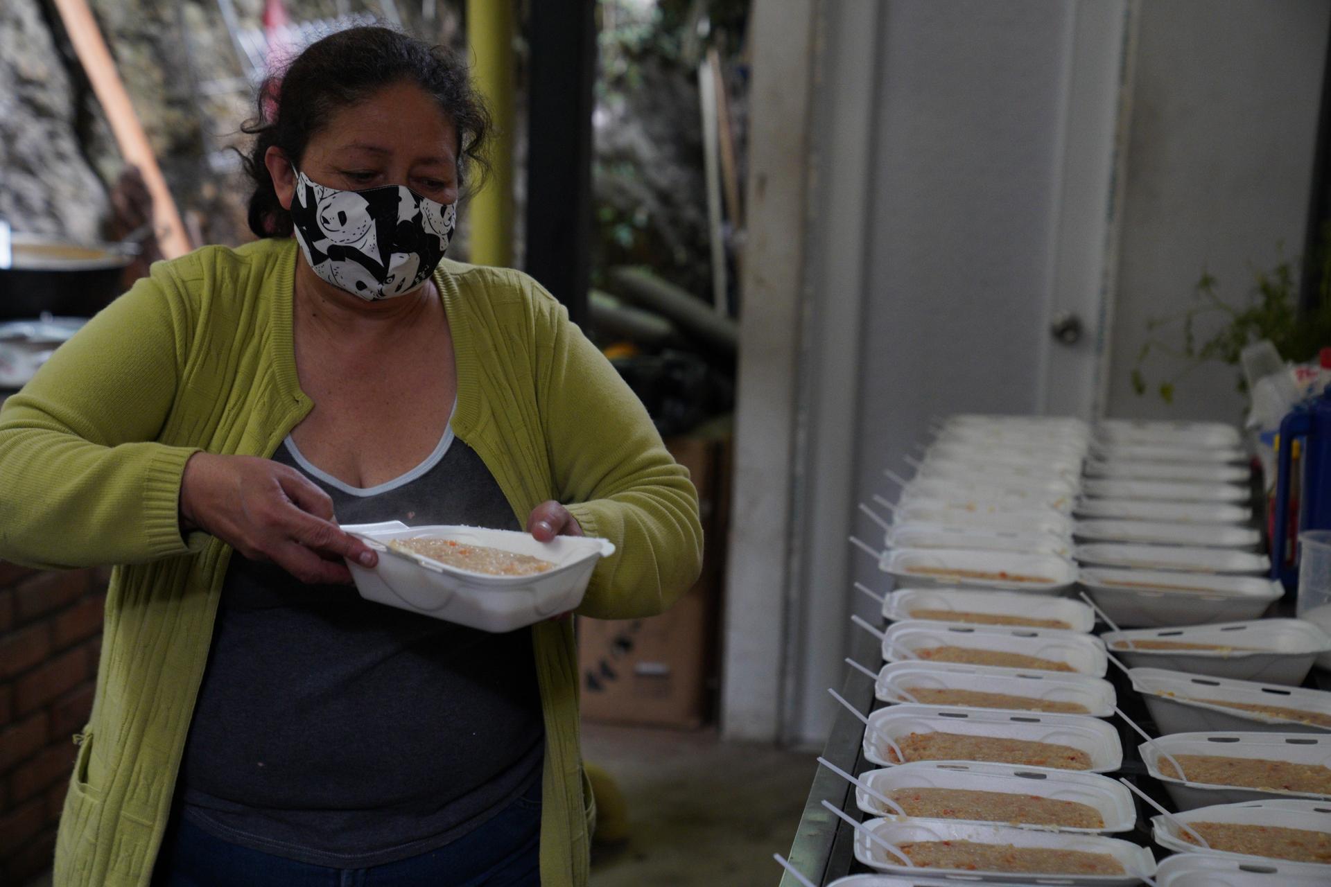 Martha Duque prepares meals for migrants at her home in Pamplona Colombia, on Oct. 1. Duque used to run a shelter for women and children but was forced to shut it down due to the pandemic. 