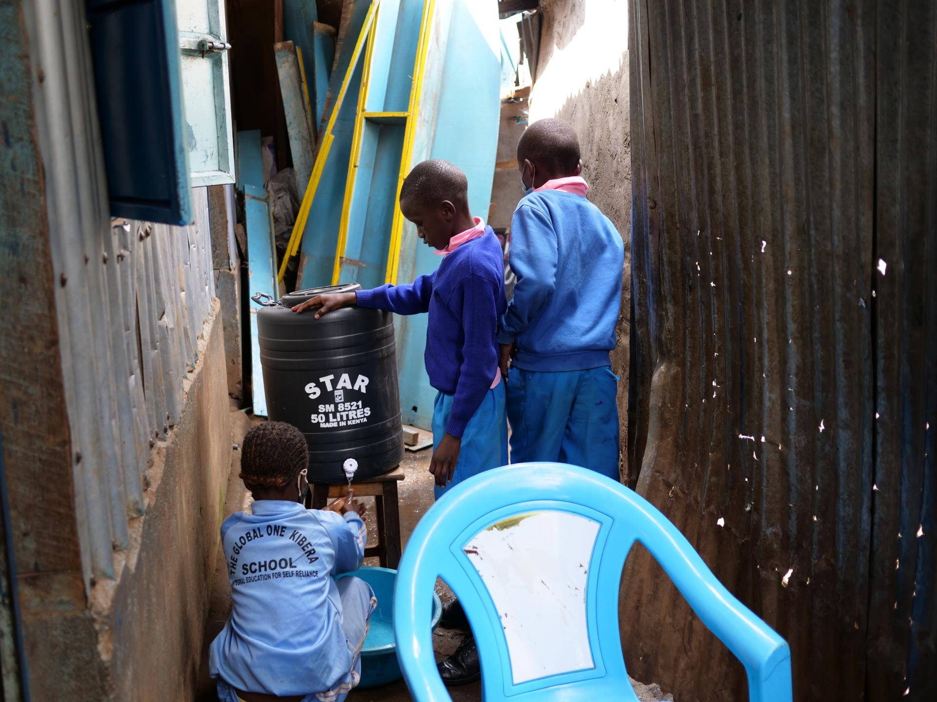 Primary school students wash their hands before a snack break at the Global One School in Nairobi, Kenya. 