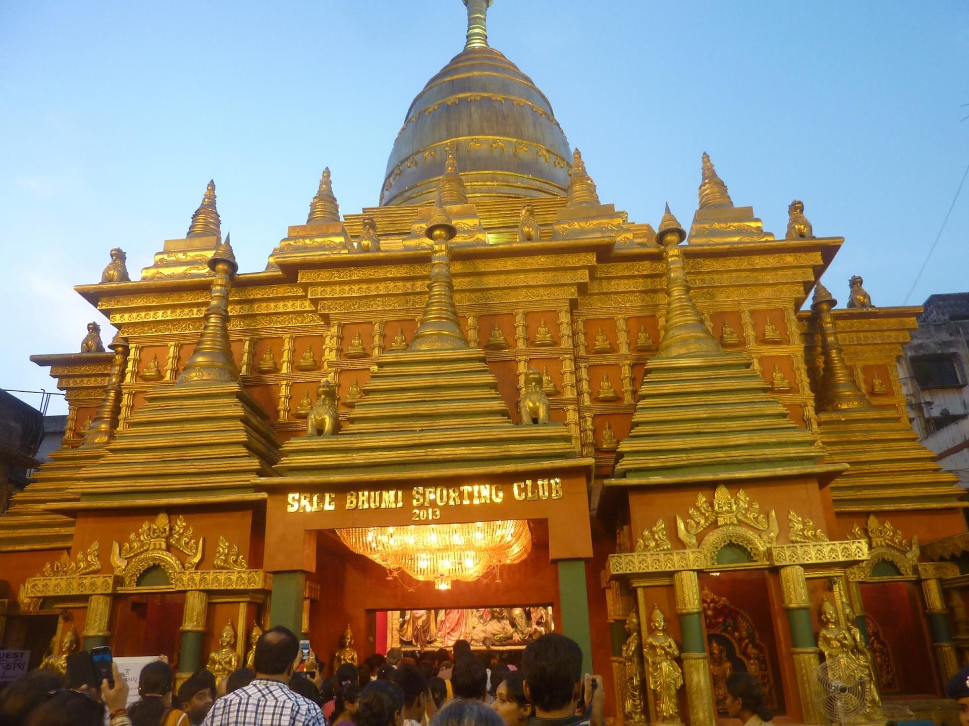 An ornate structure with golden tipped points in the shape of a Thai-style temple. 