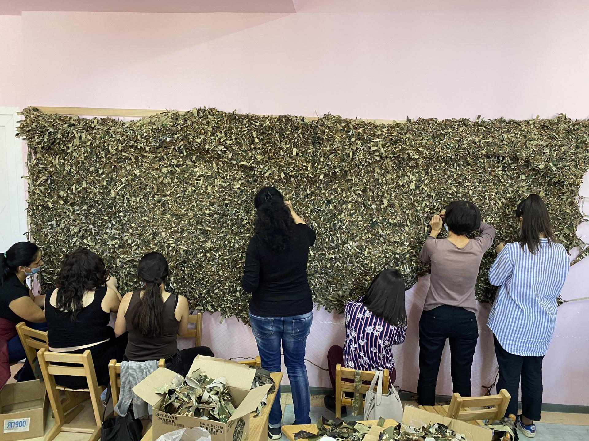 Women volunteers construct camouflage nets to be used on the Nagorno-Karabakh frontlines. 