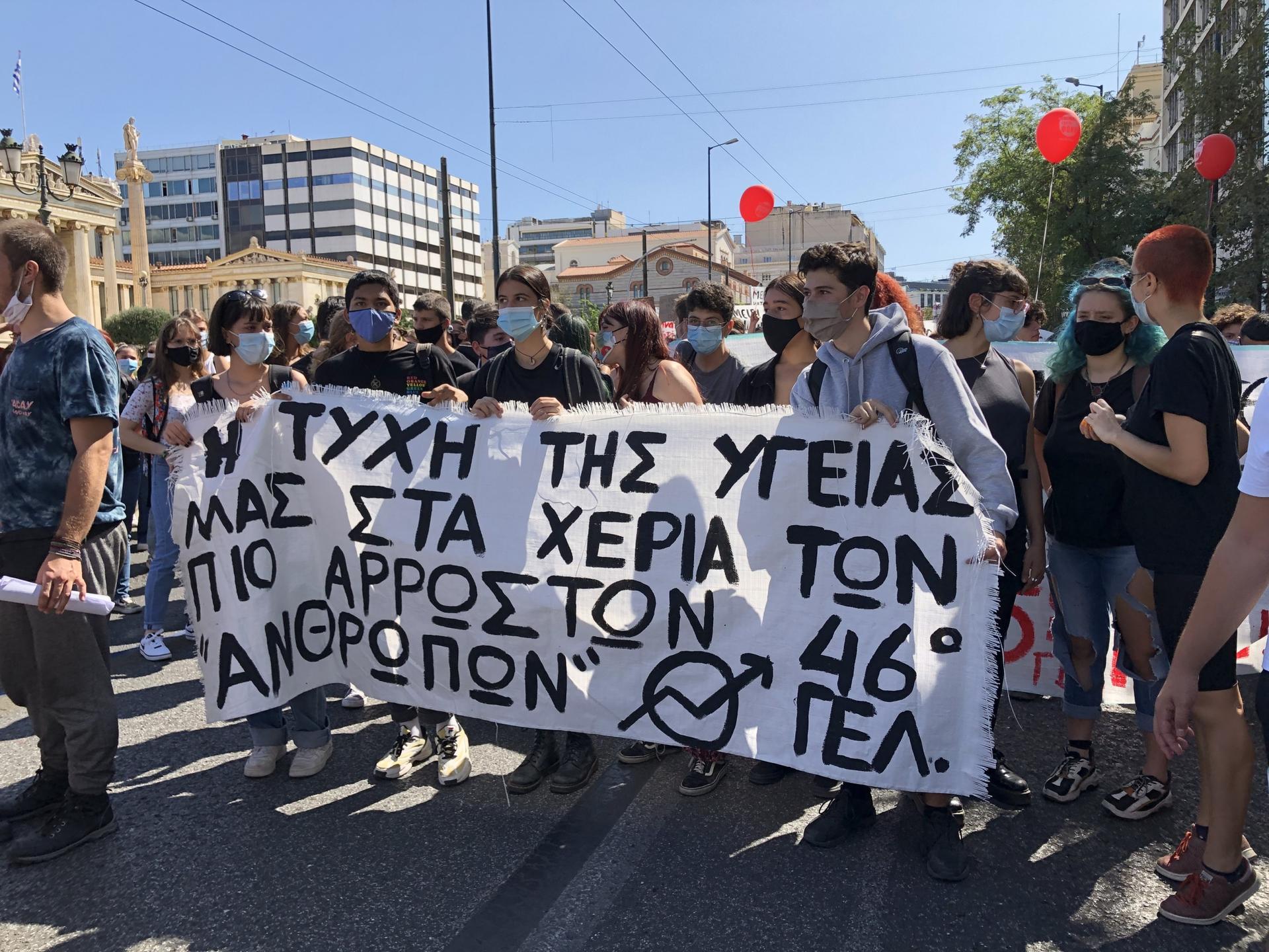 At a protest in Athens, students hold a banner that reads: 'The fate of our health in the hands of the sickest people,' referring to the administration of Greek Prime Minister Kyriakos Mitsotakis.