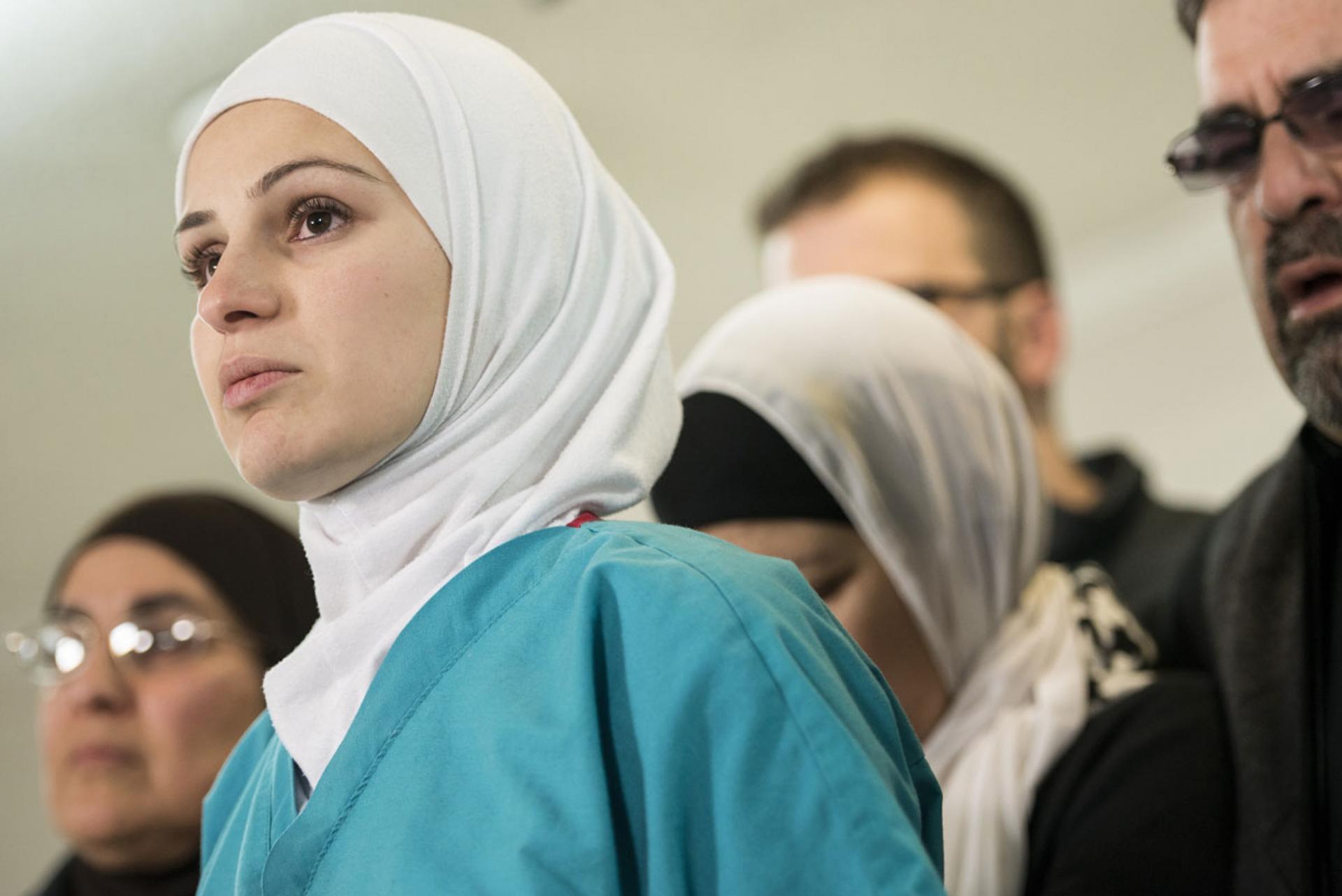Surrounded by loved ones, Dr. Suzanne Barakat speaks about her slain brother, Deah Barakat, during a press conference in February 2015 in Raleigh, N.C. Deah Barakat, his wife and her sister were killed by a neighbor. The Barakat family called it an Islamo