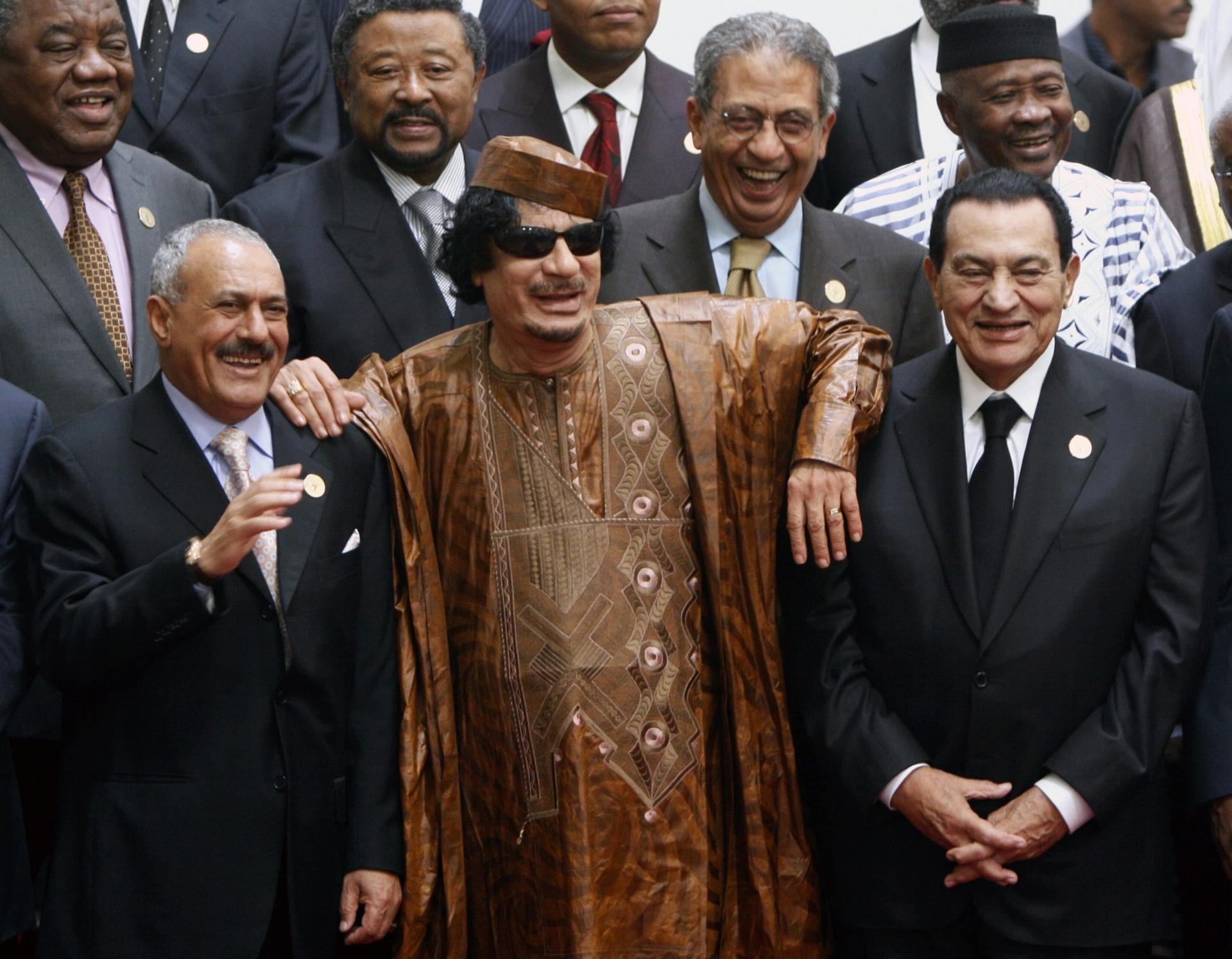 In this Oct. 10, 2010 file photo, Libyan leader Moammar Gadhafi, center, with Egyptian President Hosni Mubarak, right, and his Yemeni counterpart Ali Abdullah Saleh, left, pose during a group picture with Arab and African leaders during the second Afro-Ar