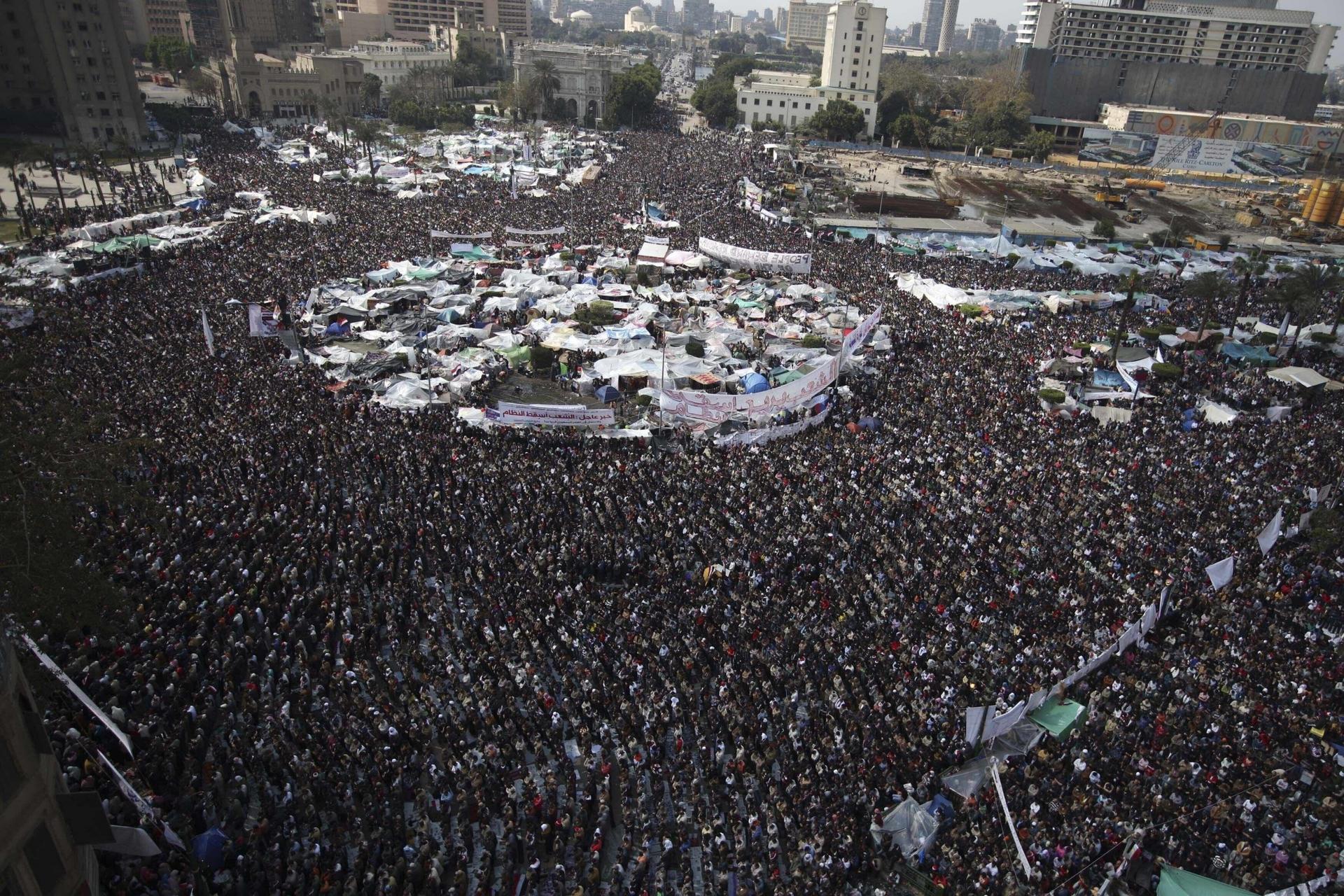 In this Feb. 11, 2011 file photo, anti-government protesters perform Friday prayers at the continuing demonstration in Tahrir Square, Cairo, Egypt.