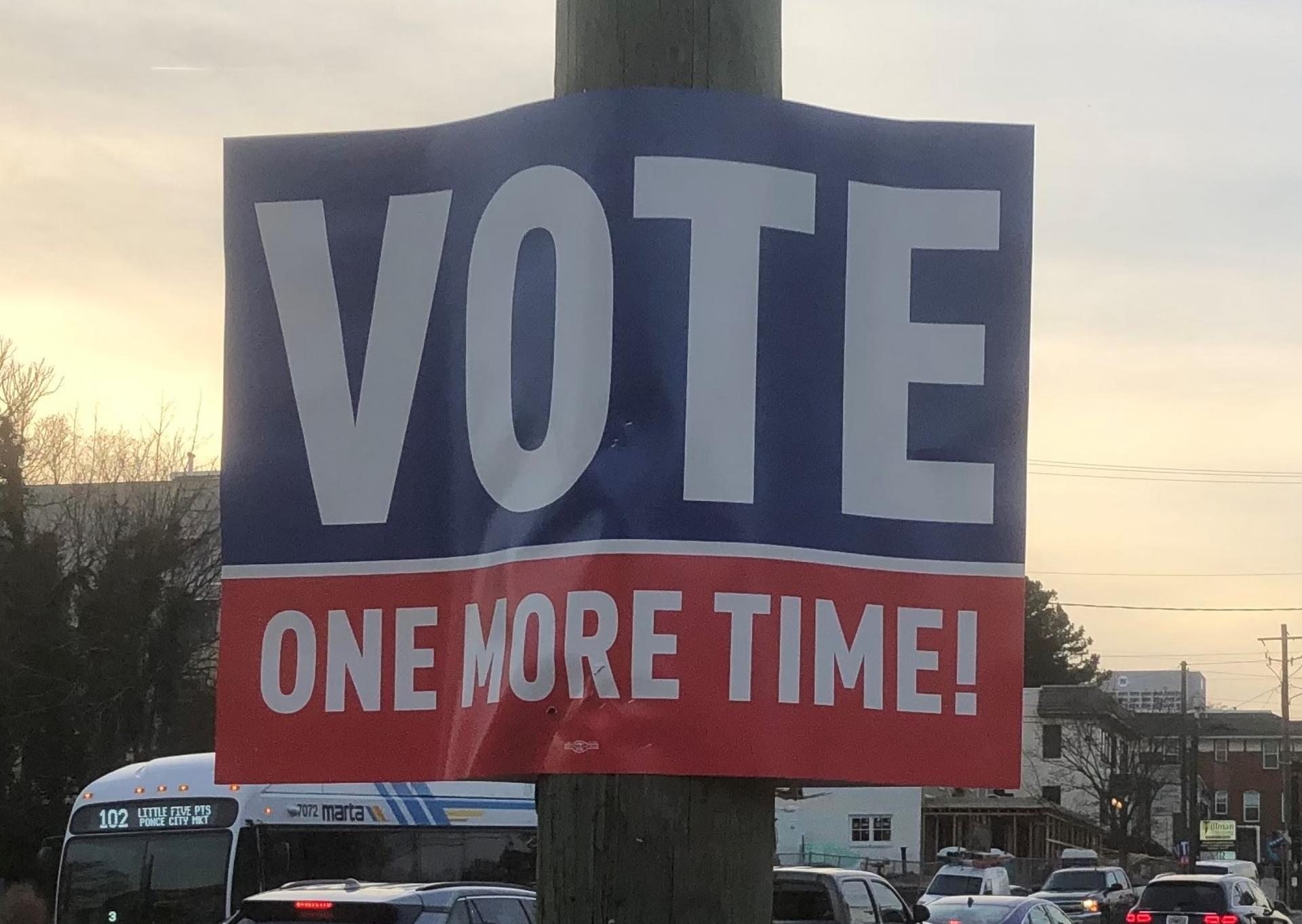 "Vote one more time" sign with blue, white and red letters. 