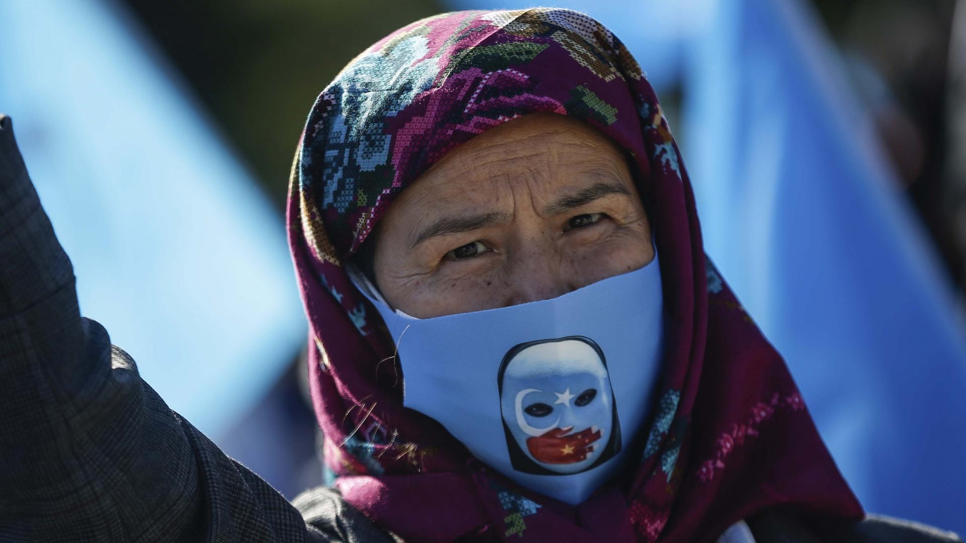 A protester from the Uighur community living in Turkey, participates in a protest in Istanbul, Oct. 1, 2020, against what they allege is oppression by the Chinese government to Muslim Uighurs in far-western Xinjiang province. 