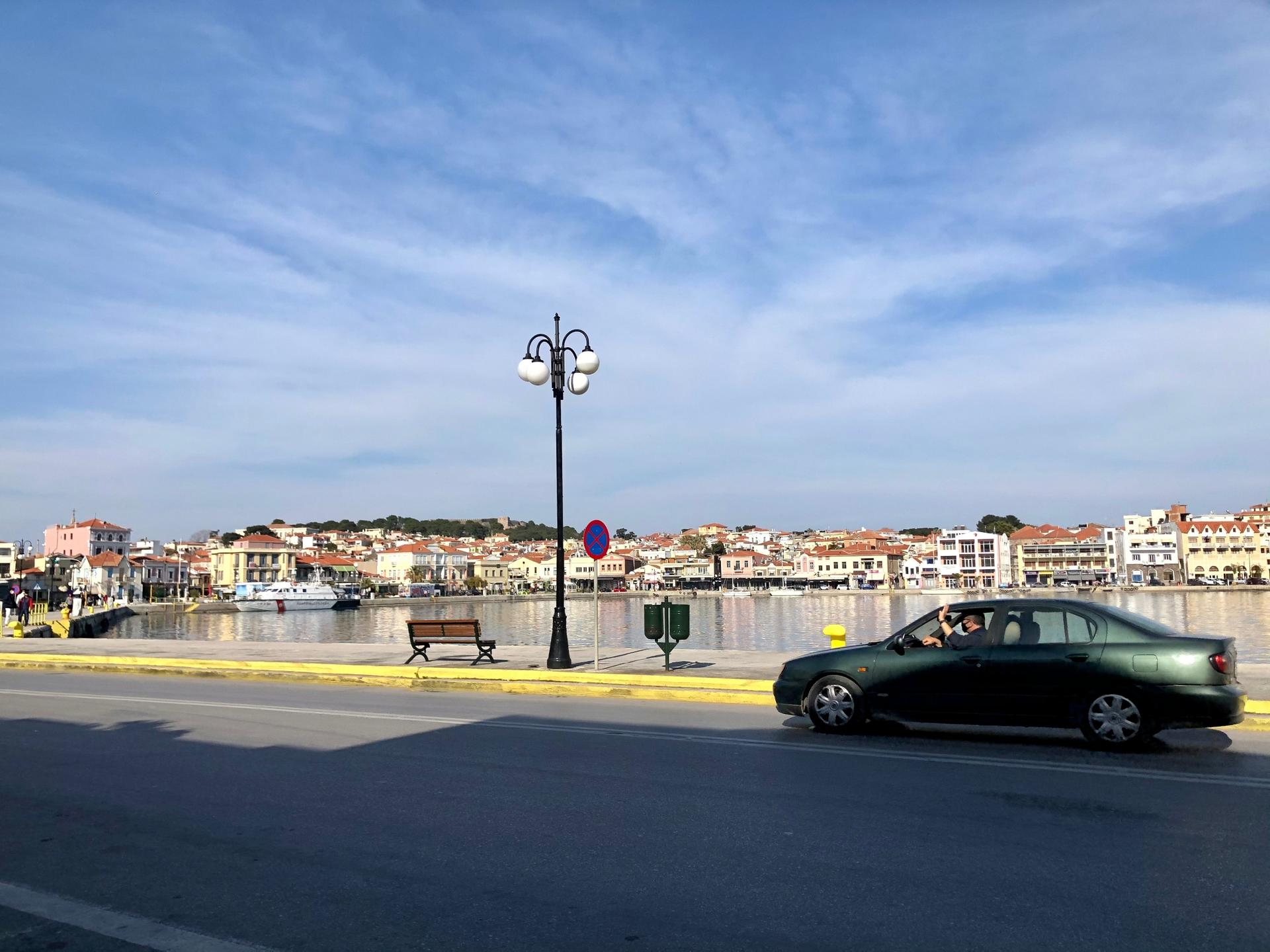 A car drives along the seaside near the port of Mytilene on Lesbos, Greece. 