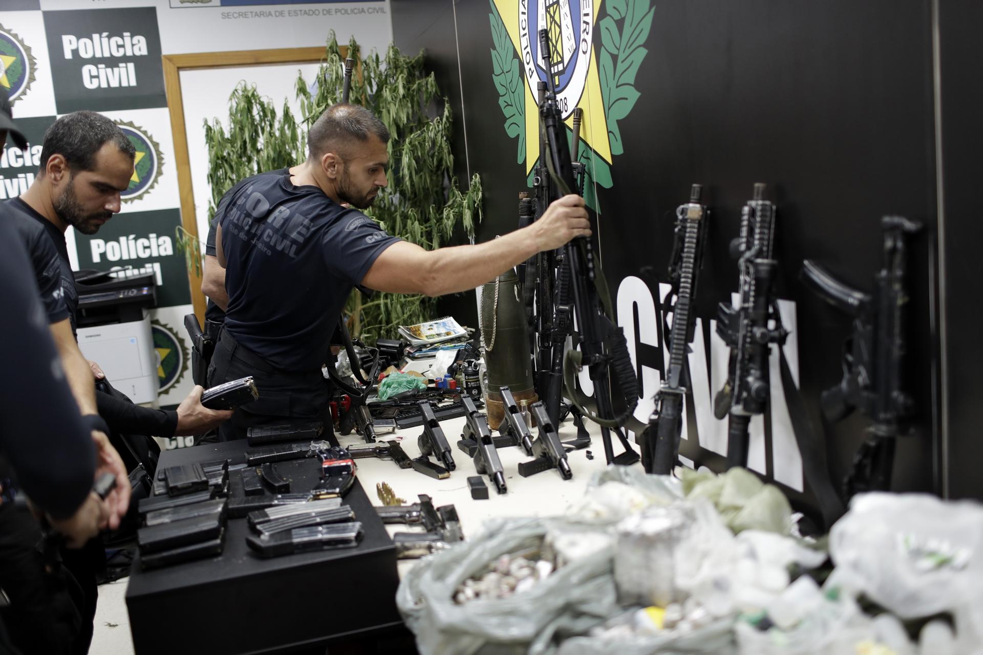 Weapons and drugs seized during a police raid are displayed for the press at city police headquarters in Rio de Janeiro, Brazil, May 6, 2021. 