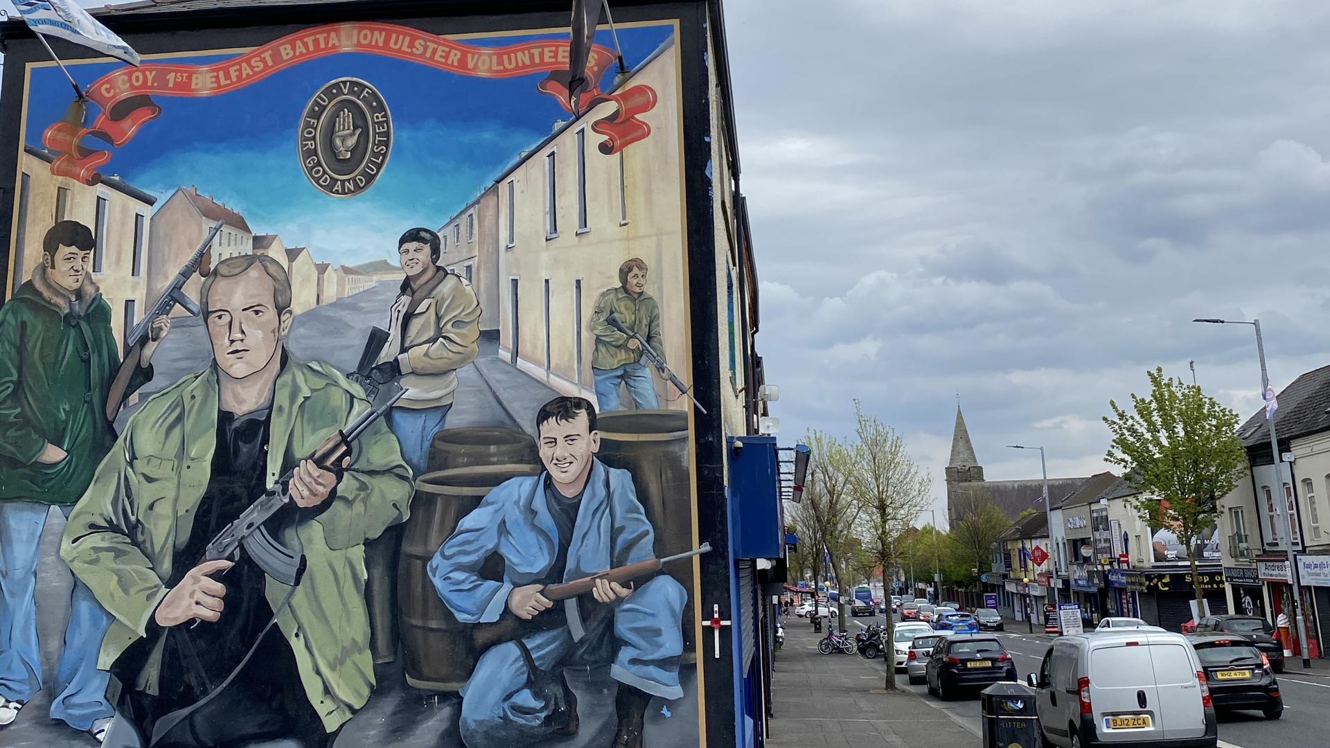 Areas of west Belfast are dominated by vivid murals depicting armed Loyalist and Republican paramilitary figures. 