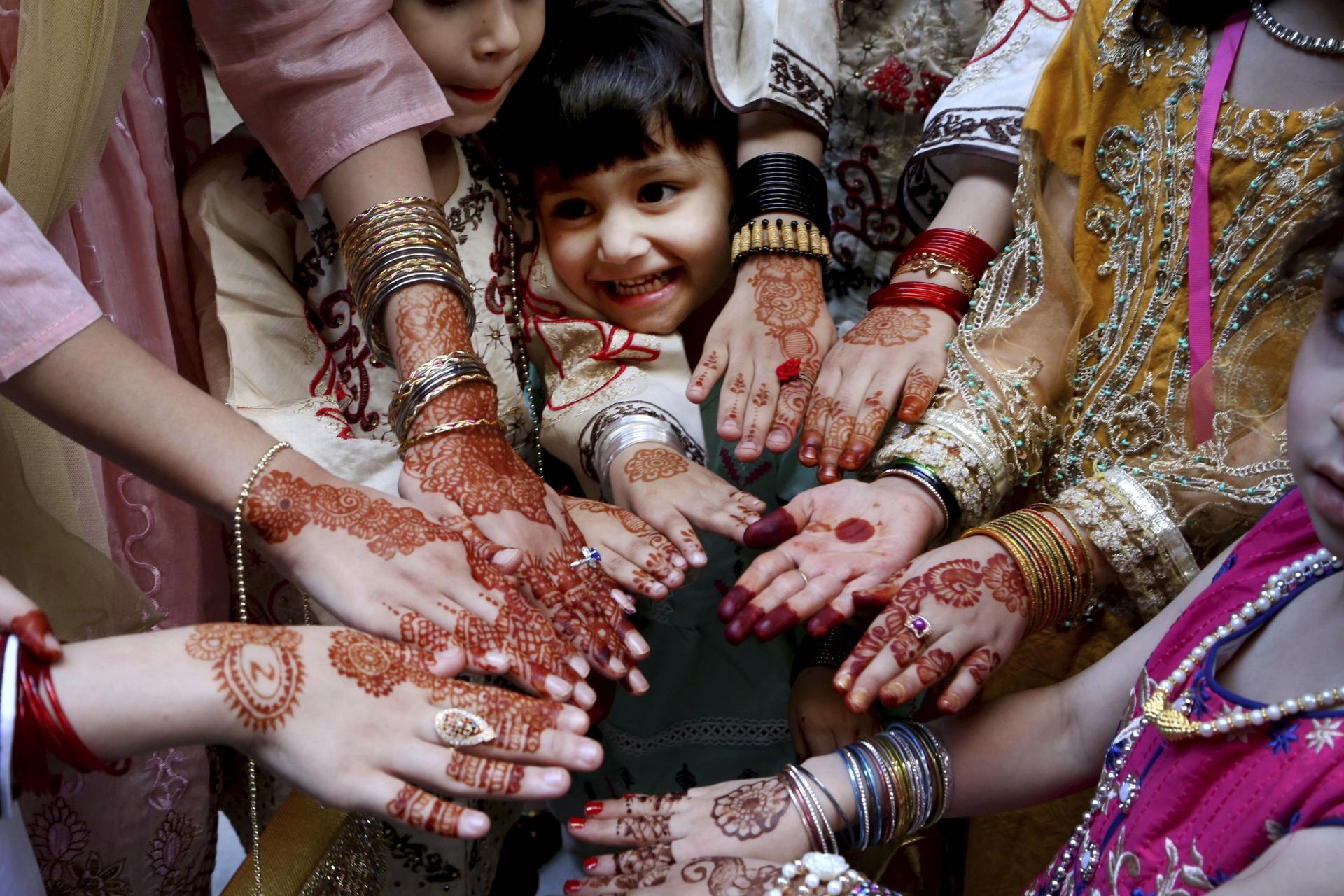 Muslim girls display their hands painted with traditional henna to celebrate Eid al-Fitr holidays, marking the end of the fasting month of Ramadan, in Peshawar, Pakistan.