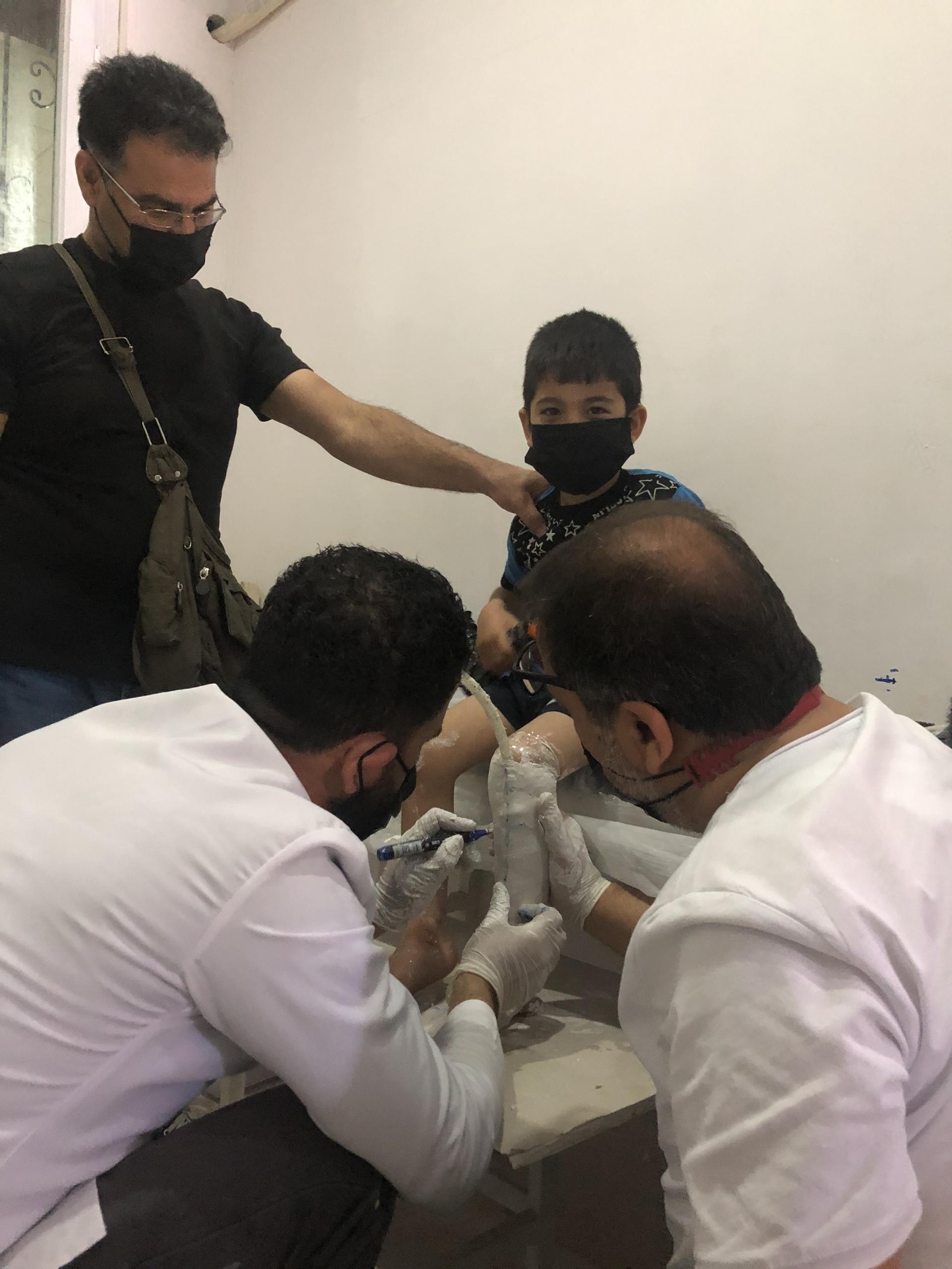 Mohamed al-Aweis (far left) said that his son, Jad, needed medical attention at birth but doctors urged him to leave immediately because there had been airstrikes nearby in recent days.