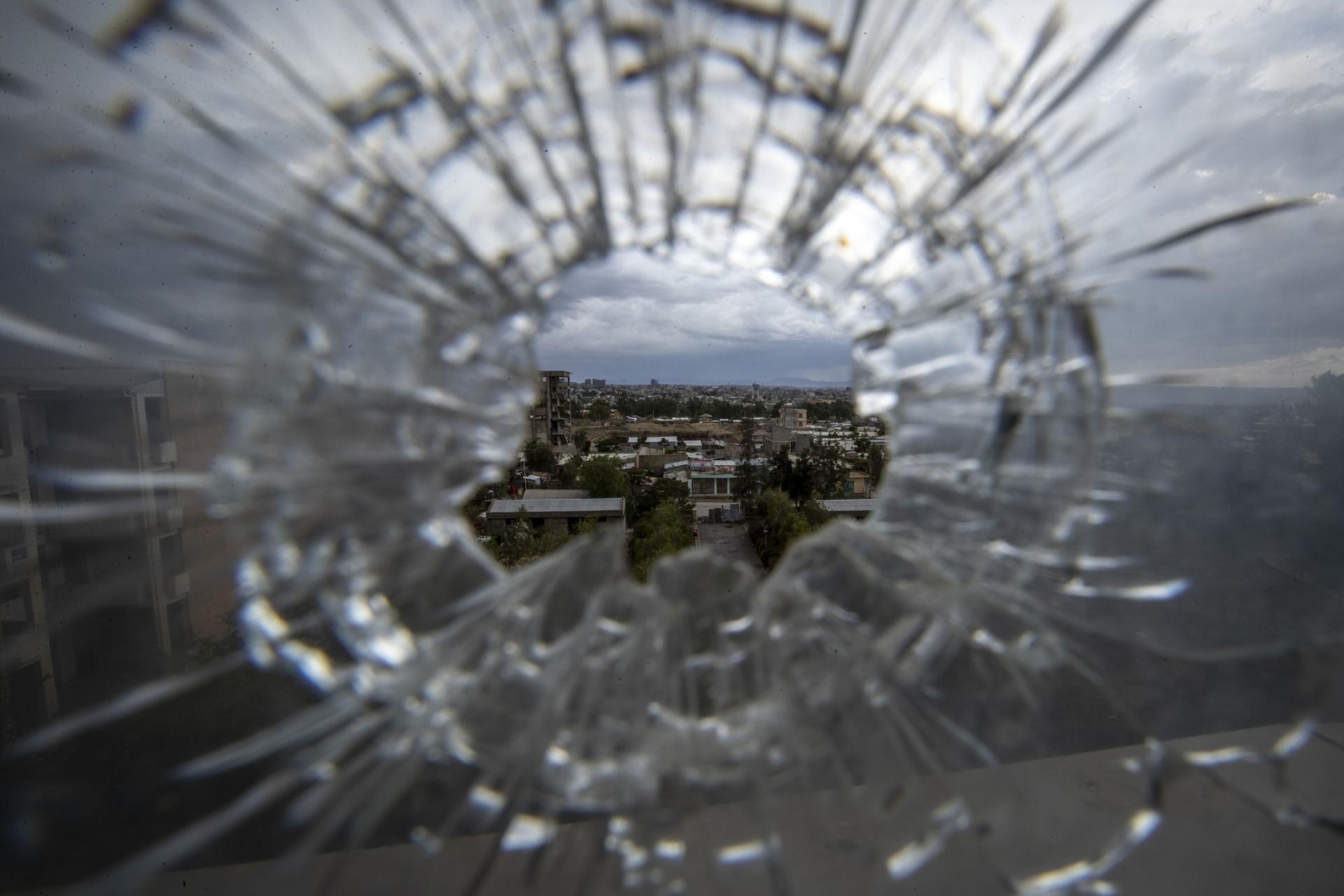 Glass shattered from bullet. 