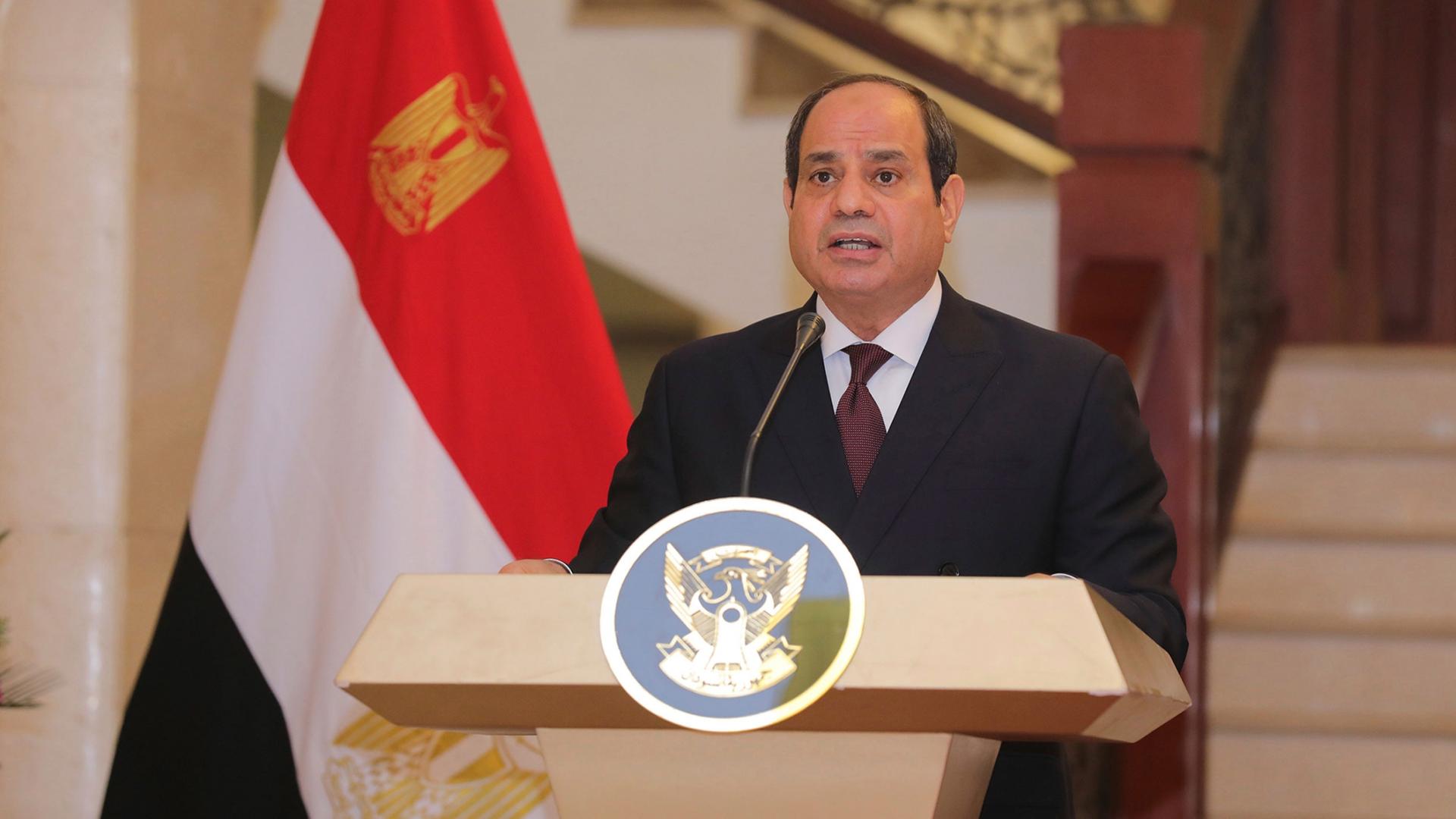 President Abdul Fattah al-Sisi at a podium with an Egyptian flag behind him