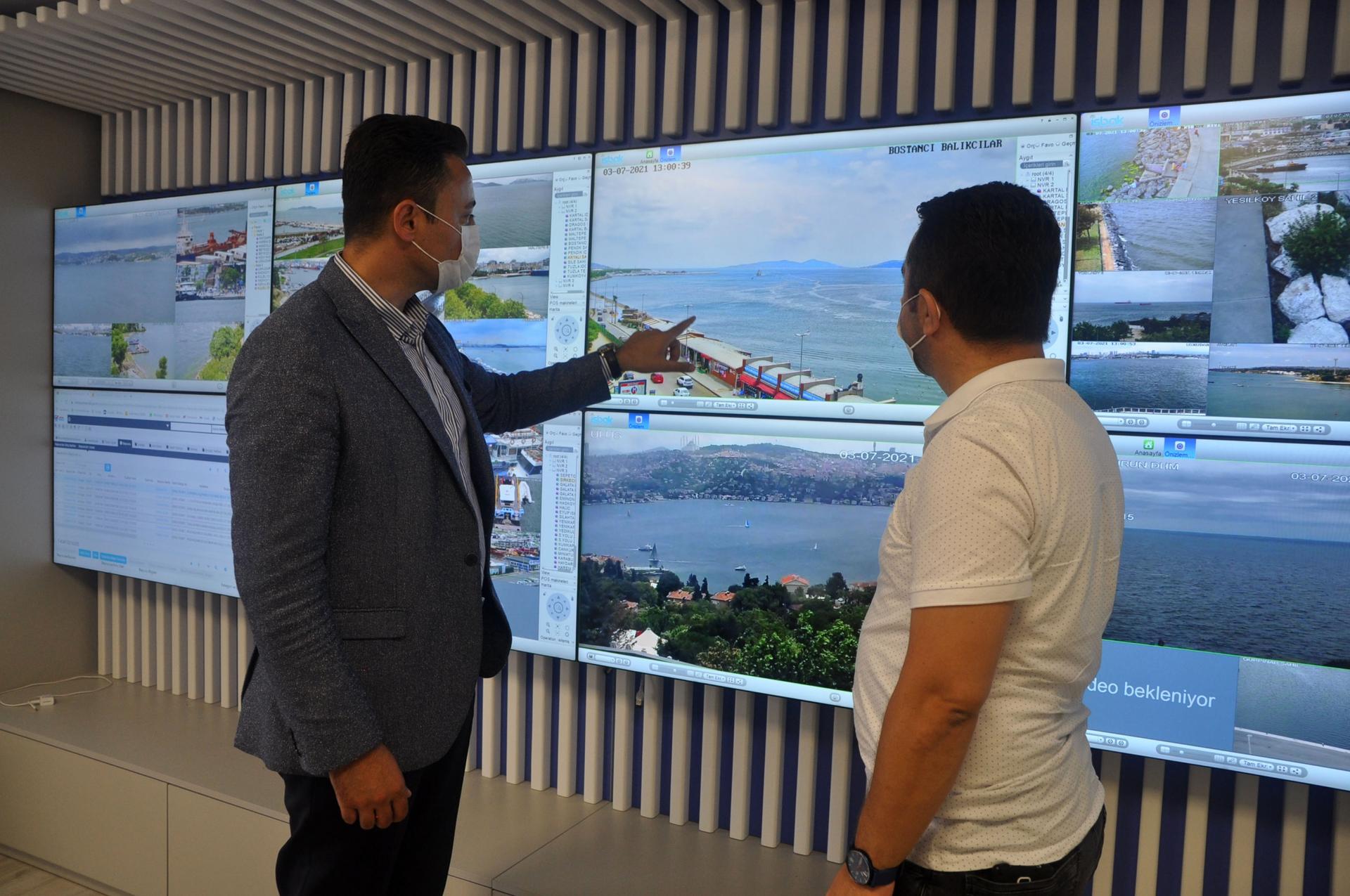 İlker Aslan (left) and Fatih Polat Timur identify a patch of sea snot near the district of Kadiköy, off Istanbul’s beach. The setup of monitors was designed by Timur to monitor litter and other pollutants emitted by ship traffic. Tips are radioed into the