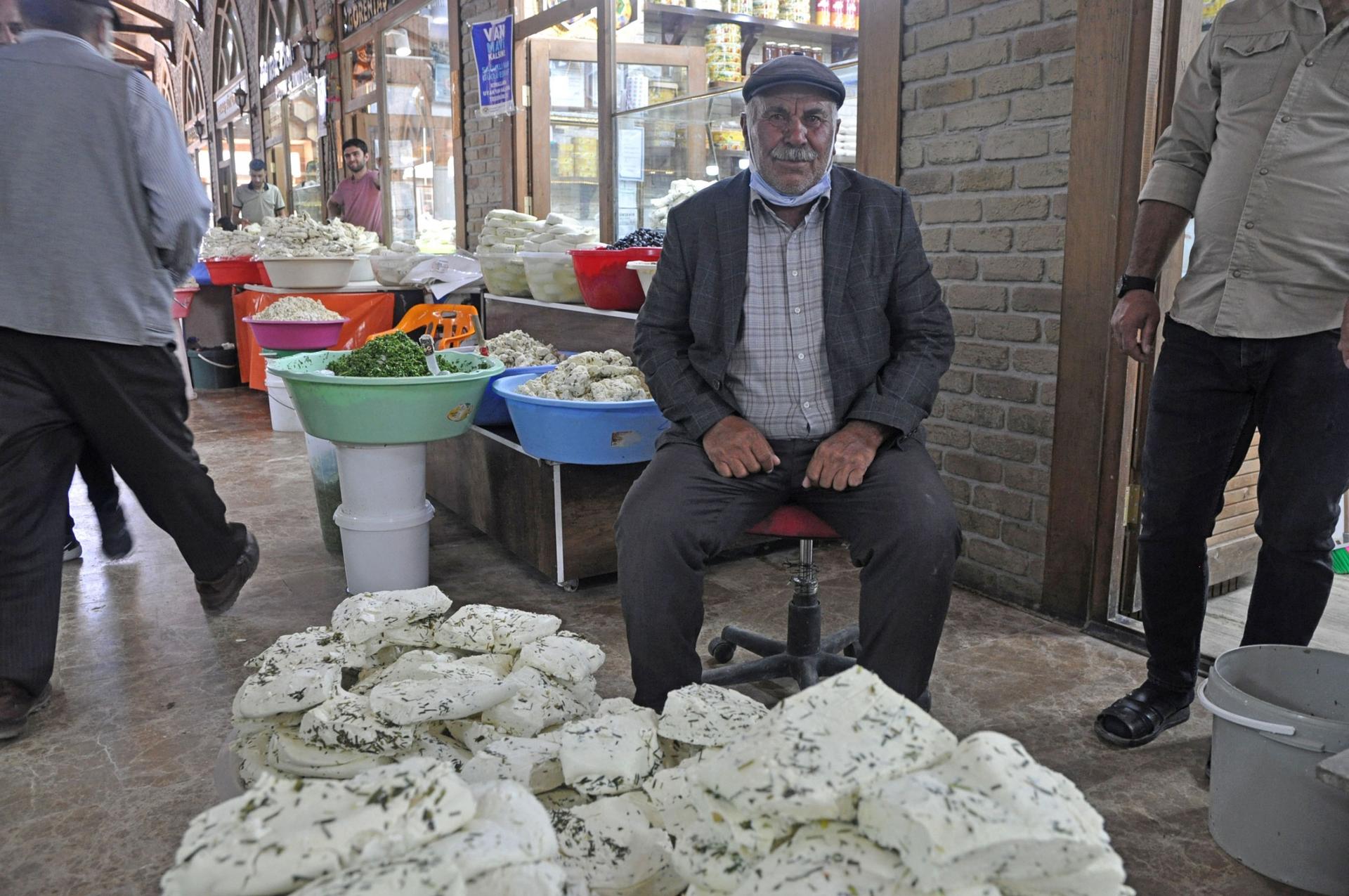 A cheese producer who gave just his first name, Islam, sits with 150 kilograms of Van Otlu Peyniri. 
