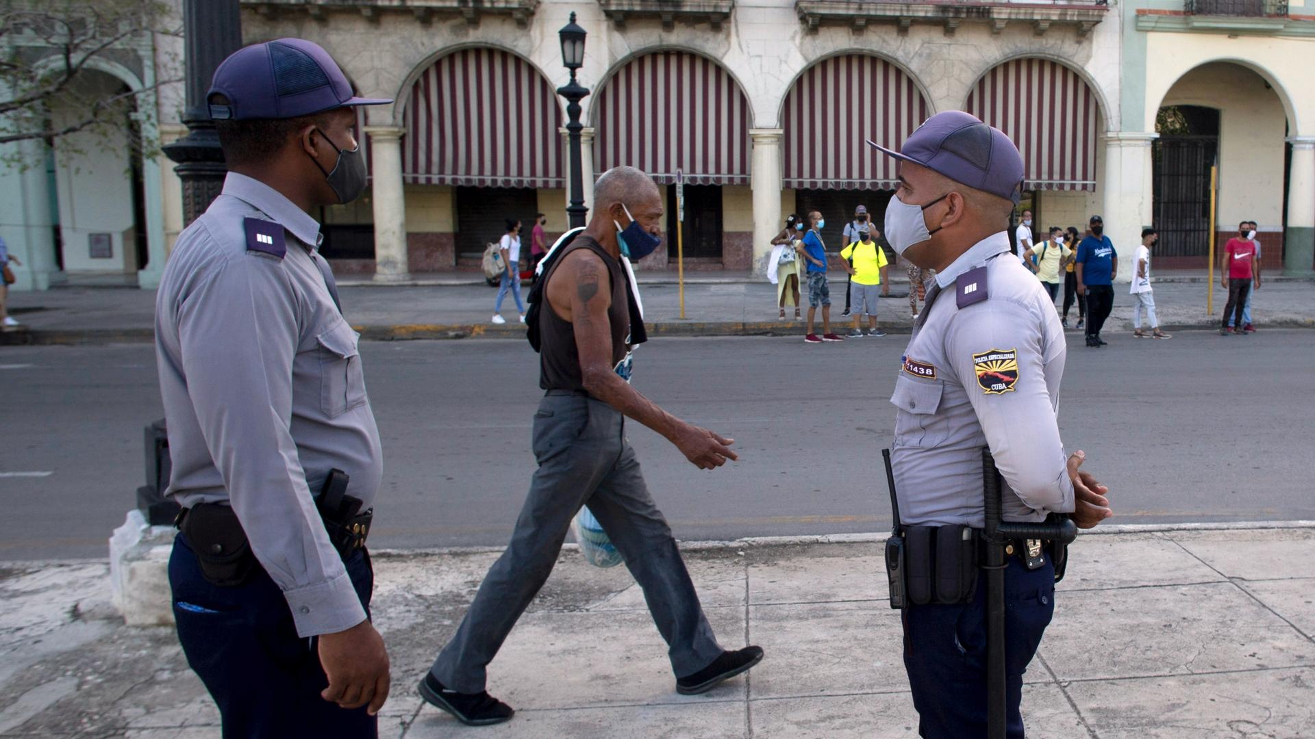 Police stand guard near the National Capitol building in Havana, Cuba, July 12, 2021, the day after protests against food shortages and high prices amid the coronavirus crisis.