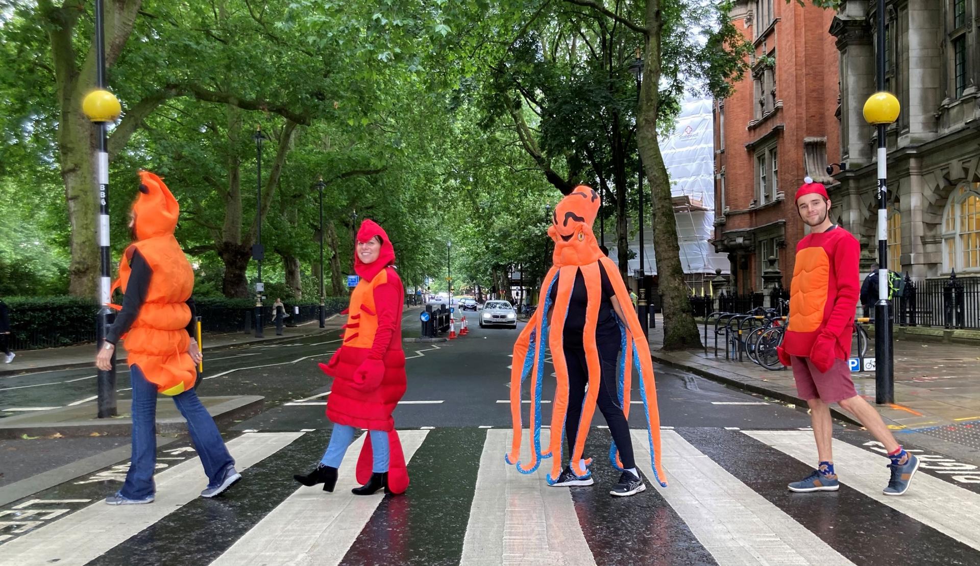 Activists with Crustacean Compassion wear shellfish costumes as they cross the street. 