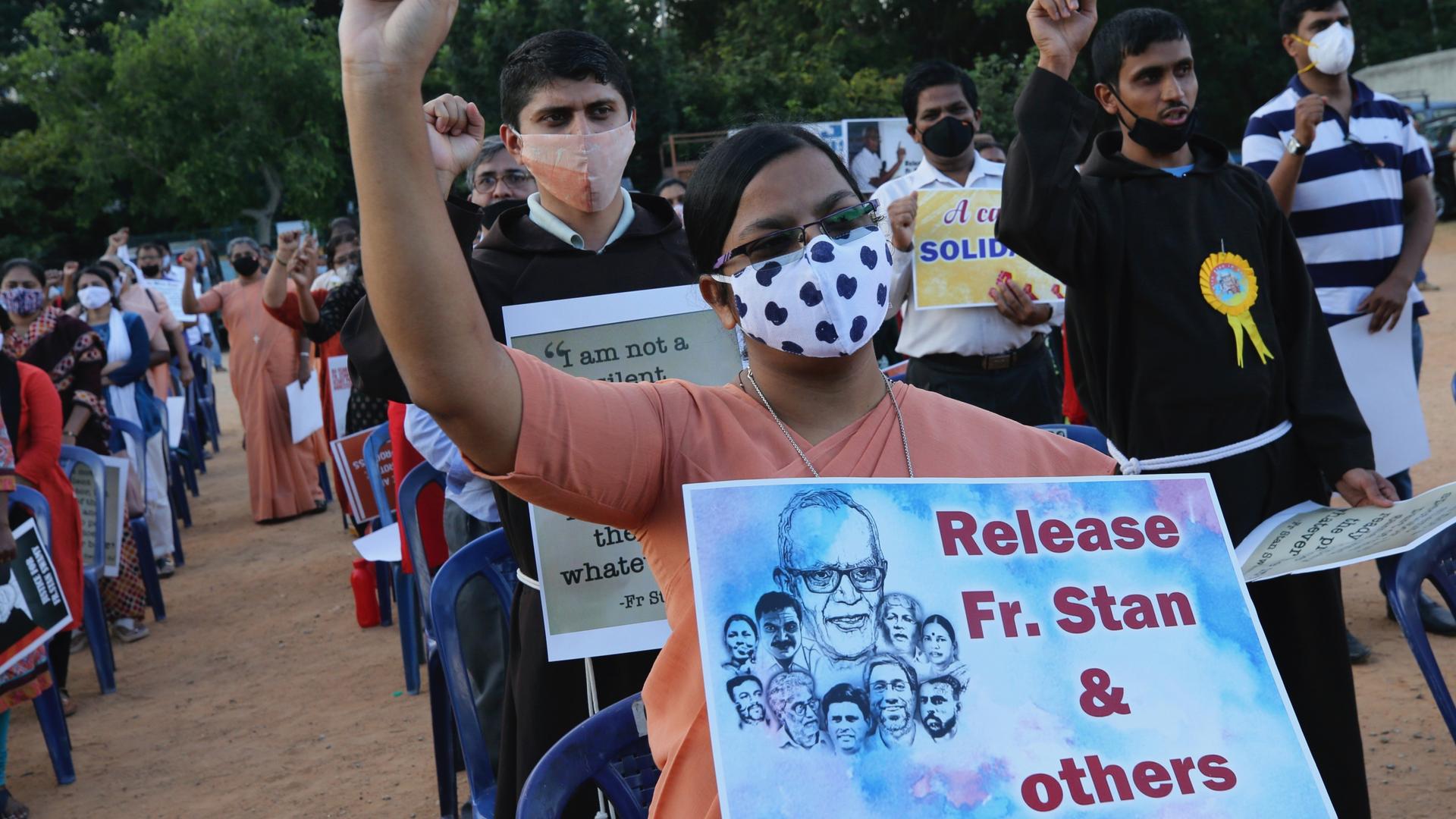 A Christian nun, center, holds a placard and shouts slogans with others demanding the release of tribal rights activist Stan Swamy and other activists during a demonstration in Bengaluru, India, Nov. 12, 200.