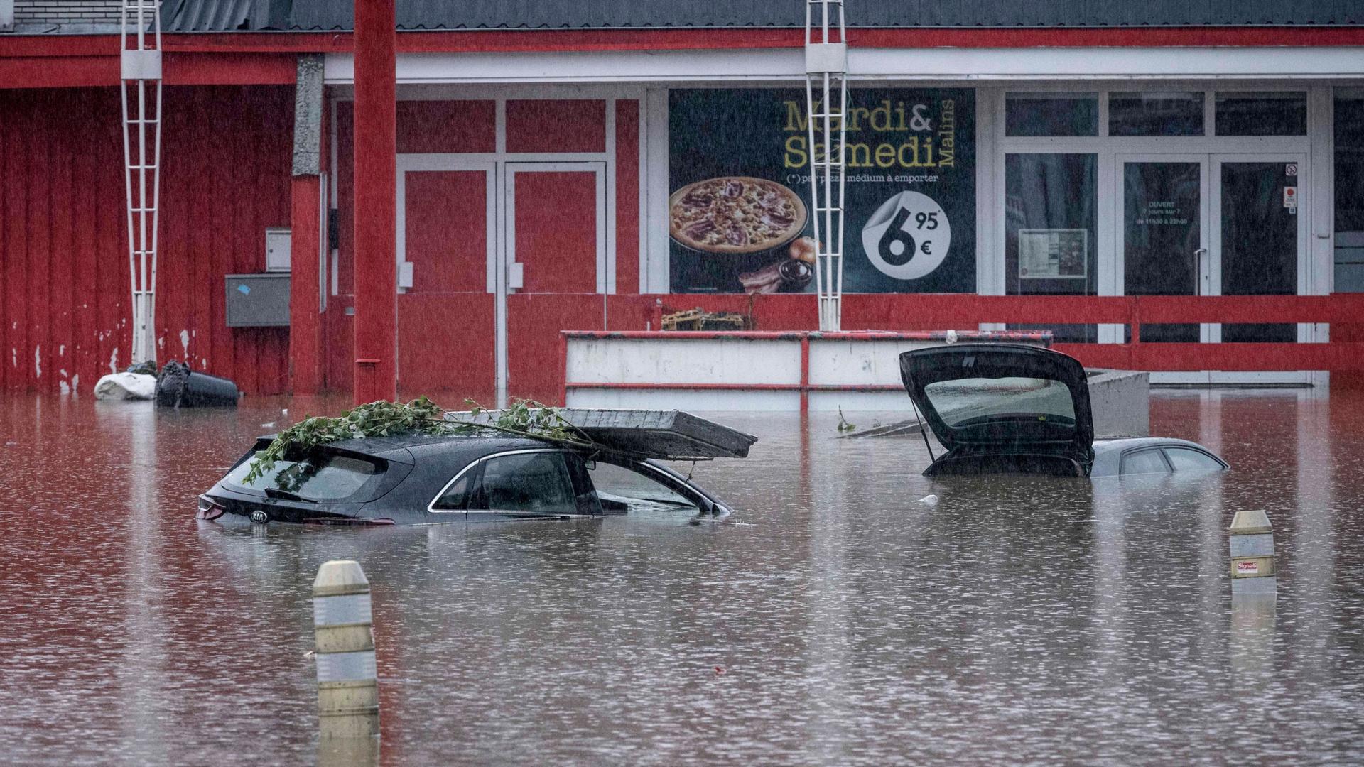 Cars are submerged in water after the Meuse River broke its banks during heavy flooding in Liege, Belgium, Thursday, July 15, 2021. 