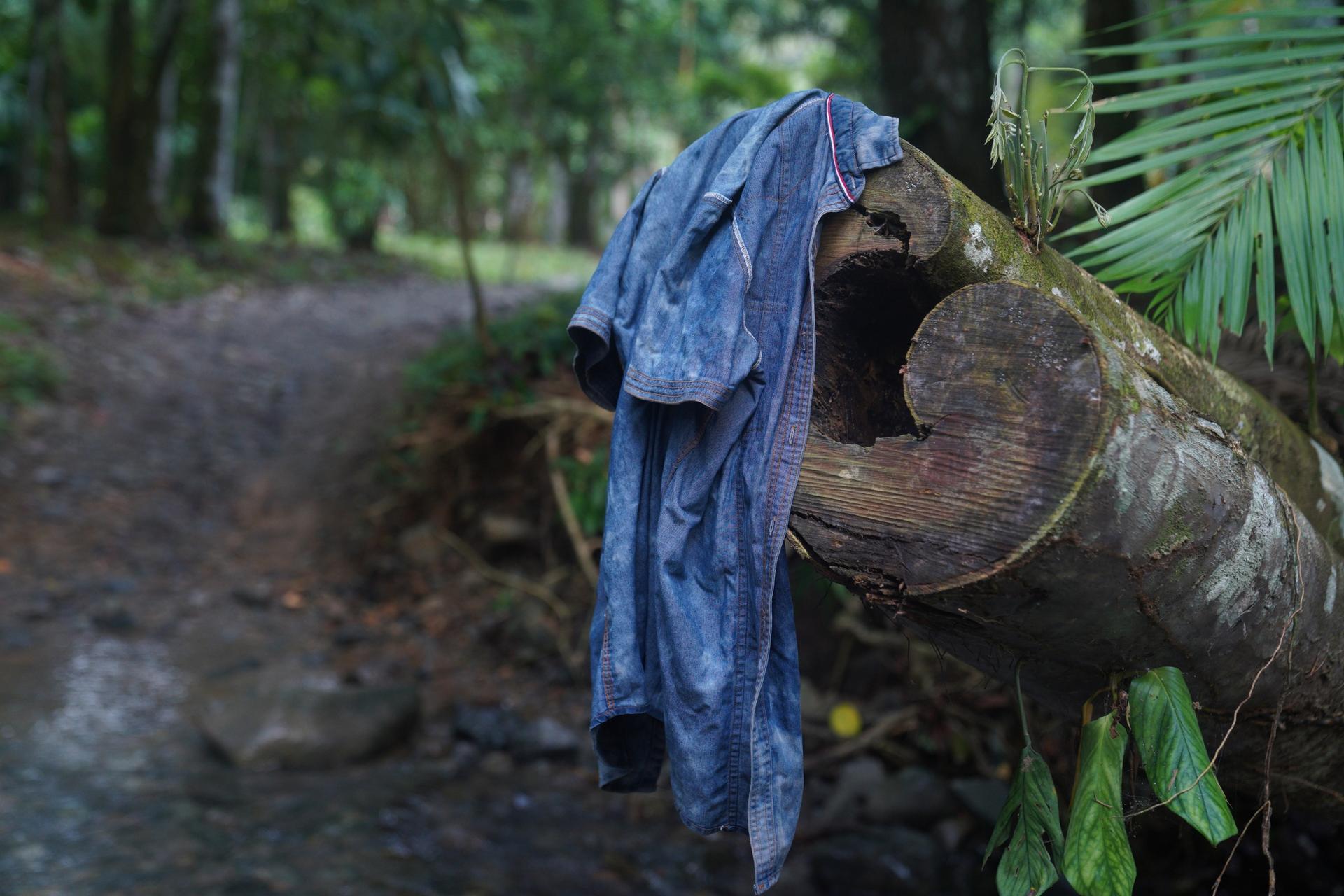 Migrants start to shed some of their belongings as they begin to trek through the Darien Gap