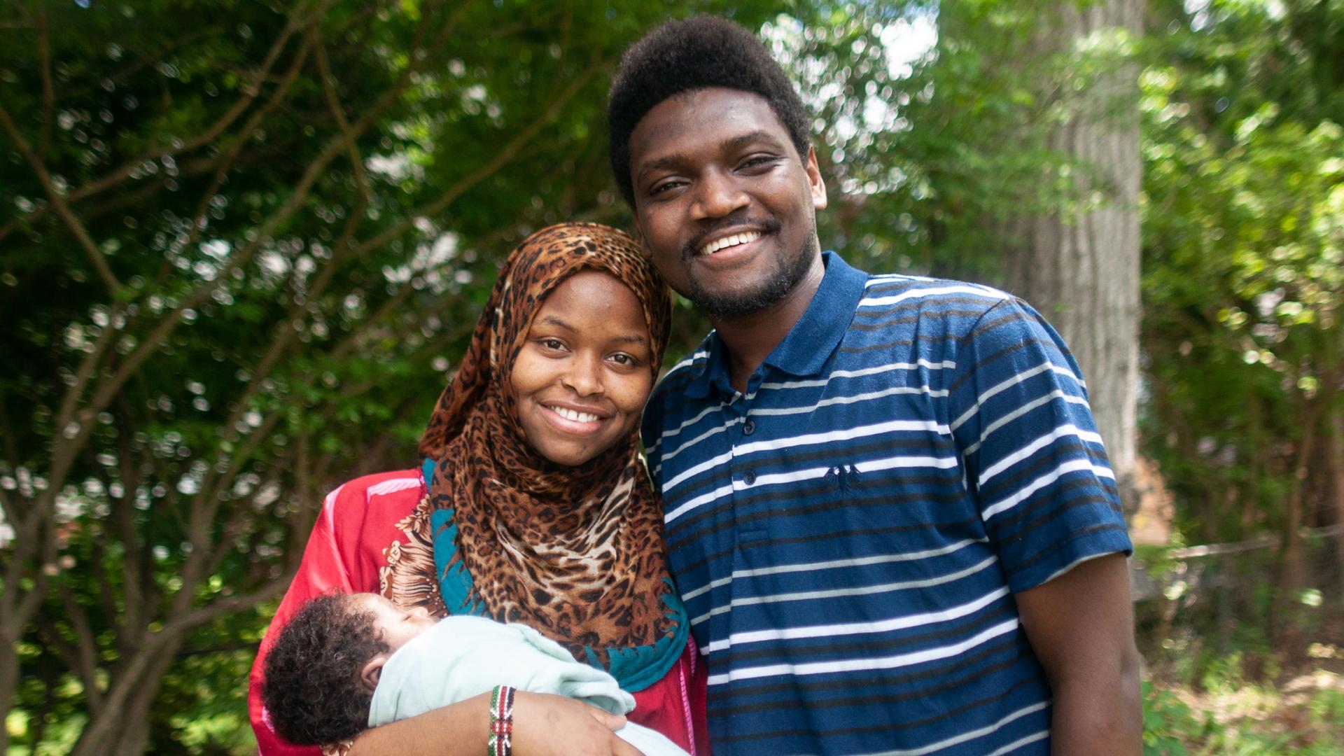 Rumbila Abdullahi and her husband, Ibrahim Abdi, hold their newborn son, Nabeel, outside their home in Springfield, Massachusetts. 