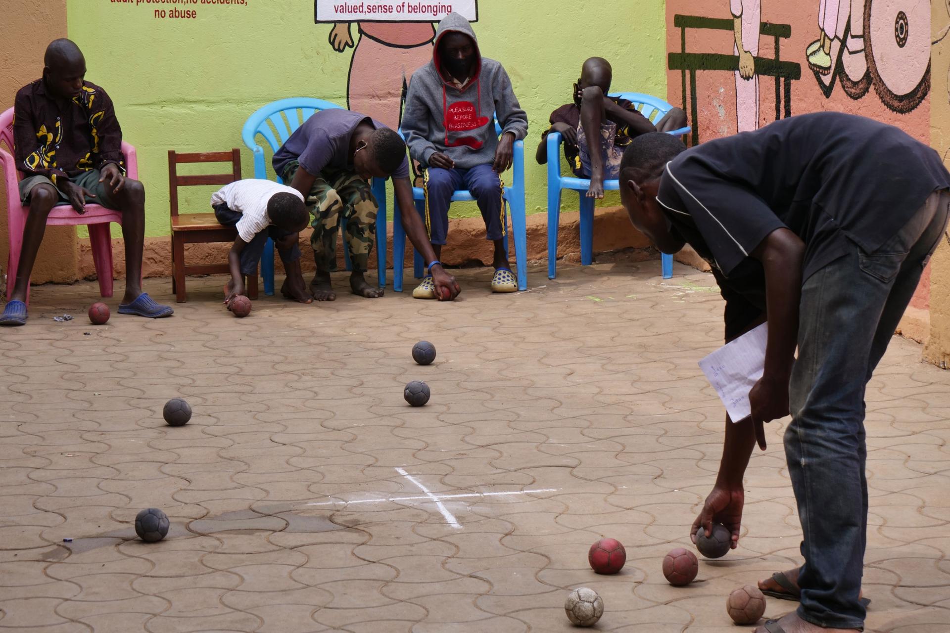 Children and youth with disabilities play bocca at Support Disabled Children Ggaba organization in Kampala, Sept. 1, 2021.