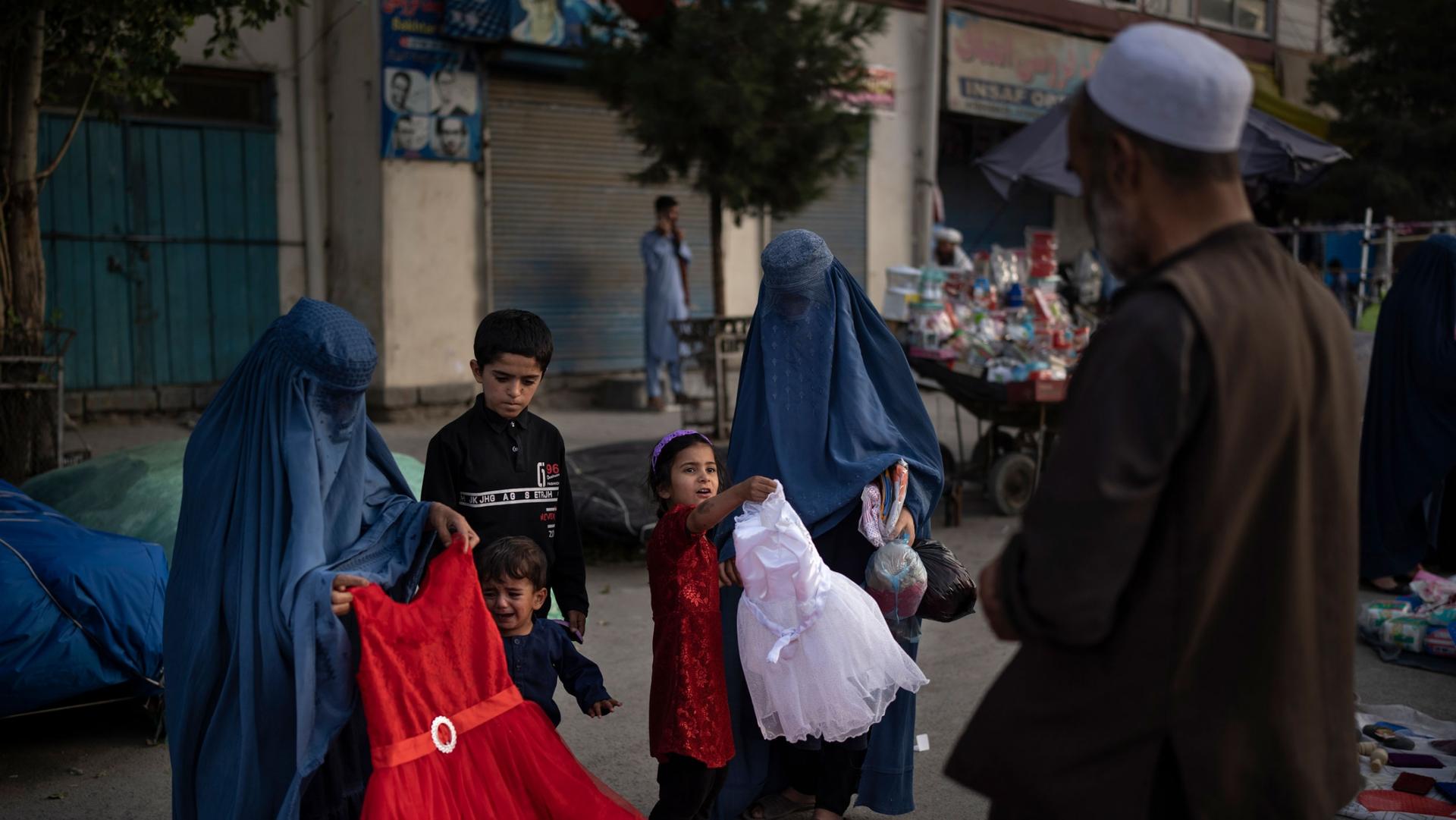 fghan women and a girl shop for dresses at a local market in Kabul, Afghanistan, Friday, Sept. 10, 2021.