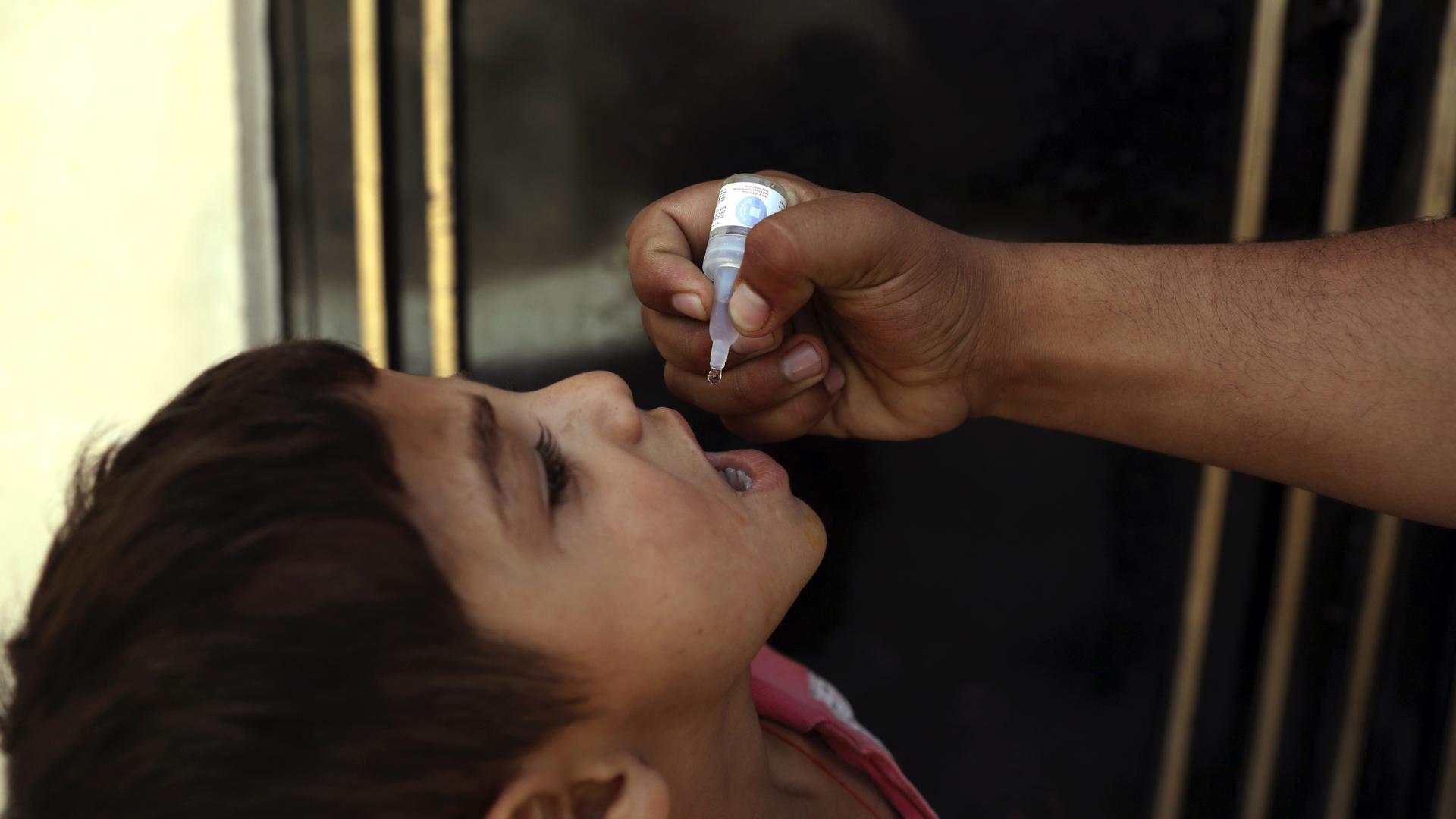 A health worker administers a vaccination to a child during a polio campaign in the old part of Kabul, Afghanistan, June 15, 2021. UN agencies are gearing up to vaccinate all of Afghanistan’s children under 5 against polio after the Taliban agreed to the 