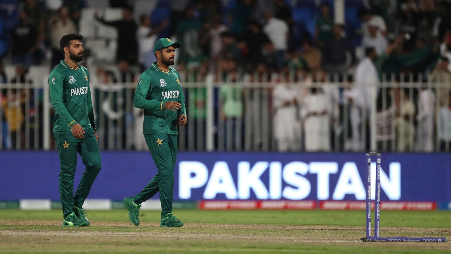 Pakistan's captain Babar Azam, right, and teammate Shadab Khan leave the field after their win in the Cricket Twenty20 World Cup match against Scotland in Sharjah, UAE