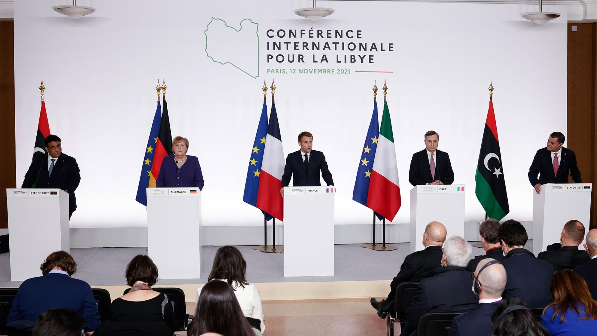 Head of the Presidential Council of Libya Mohamed al-Manfi, German Chancellor Angela Merkel, French President Emmanuel Macron, Italian Prime Minister Mario Draghi and Libyan Prime Minister Abdul Hamid Dbeibah attend a press conference on Libya in Paris