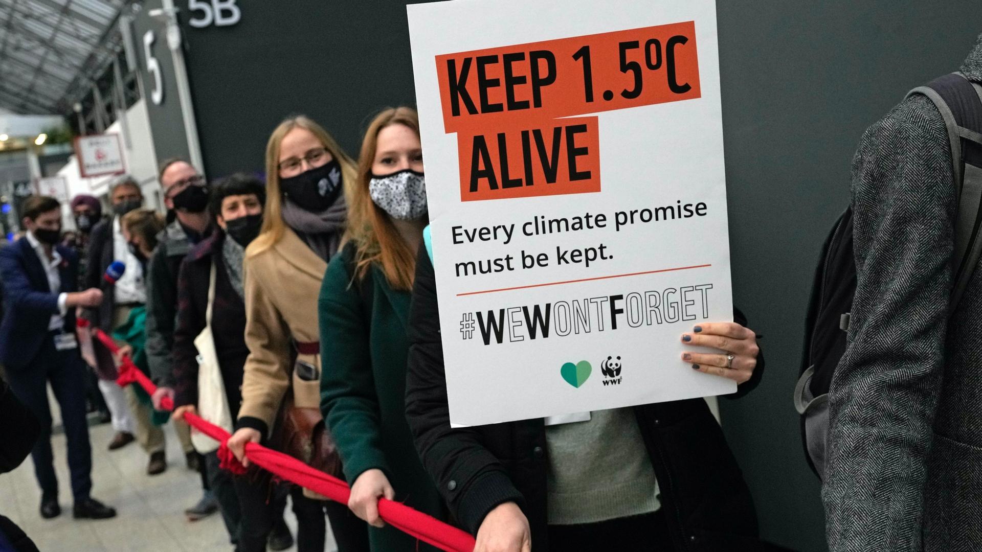Climate activists hold a demonstration through the venue of the COP26 UN Climate Summit in Glasgow, Scotland, Nov. 12, 2021. Negotiators from almost 200 nations were making a fresh push to reach agreements on a series of key issues that would allow them t