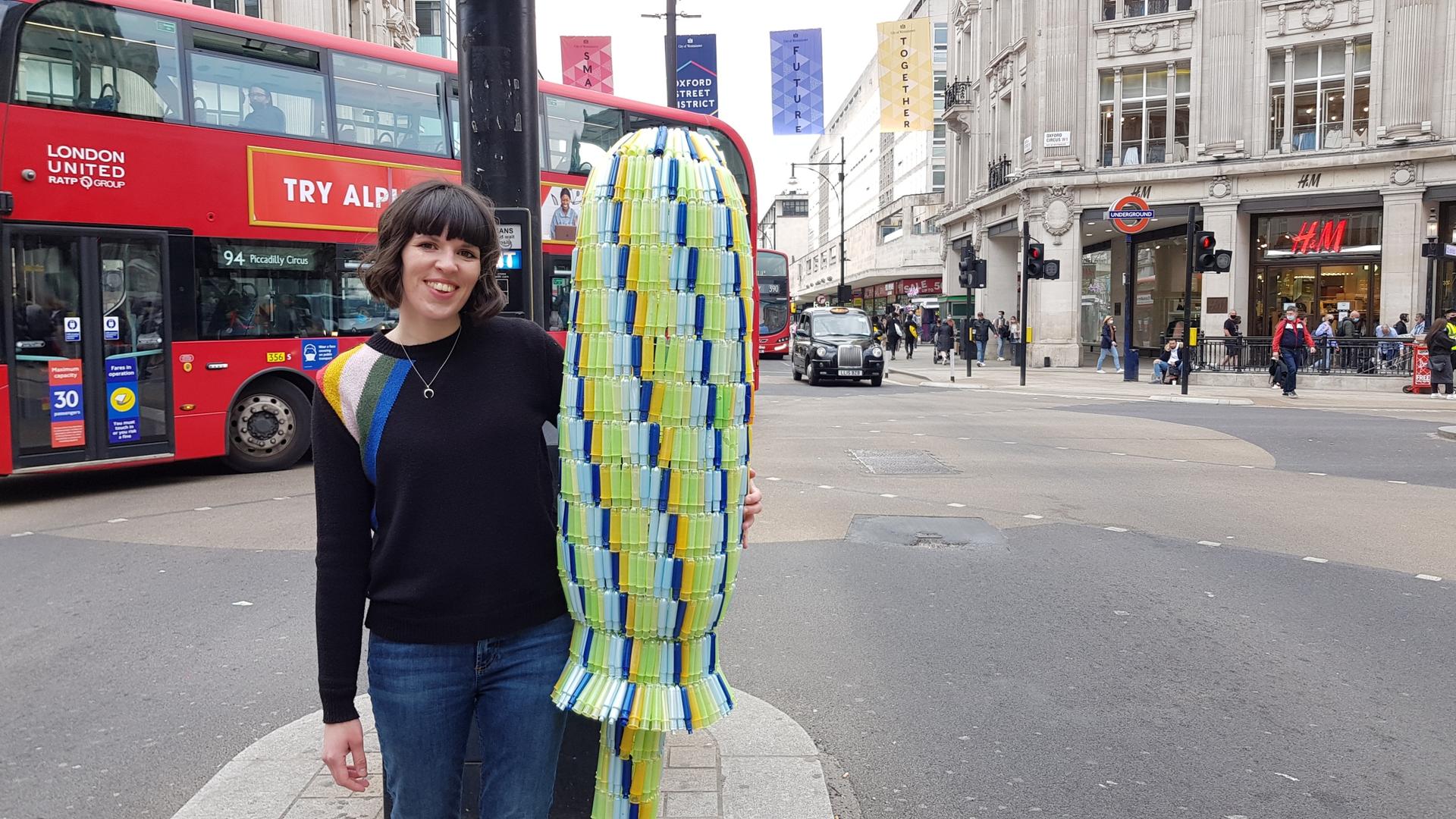 UK environmental activist Ella Daish is shown with the giant tampon she made out of over a thousand used tampons.