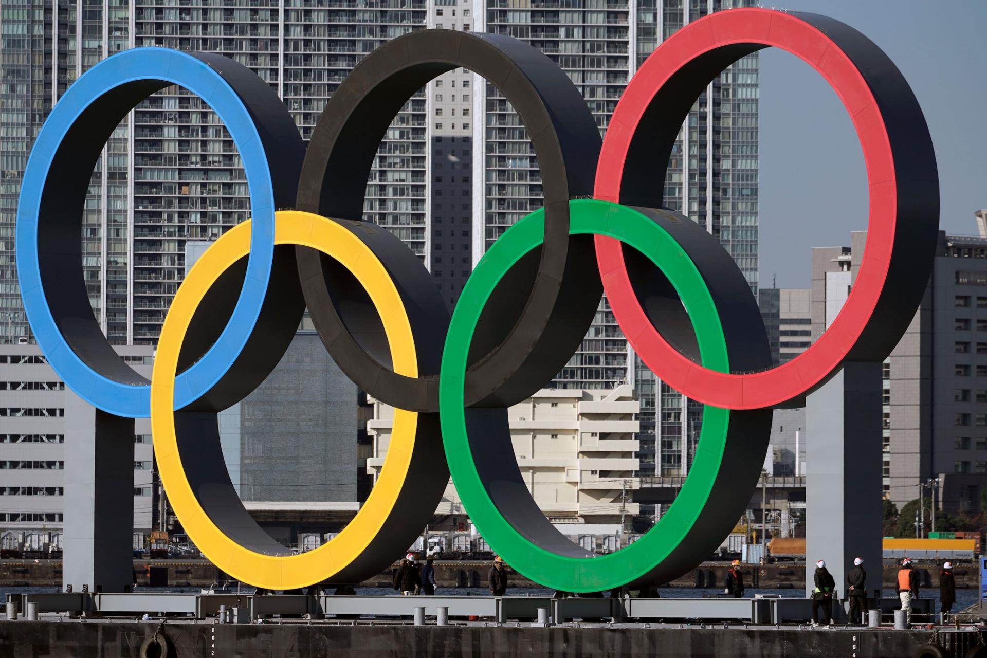 In this Dec. 1, 2020, file photo, the Olympic symbol is reinstalled after it was taken down for maintenance ahead of the postponed Tokyo 2020 Olympics. 