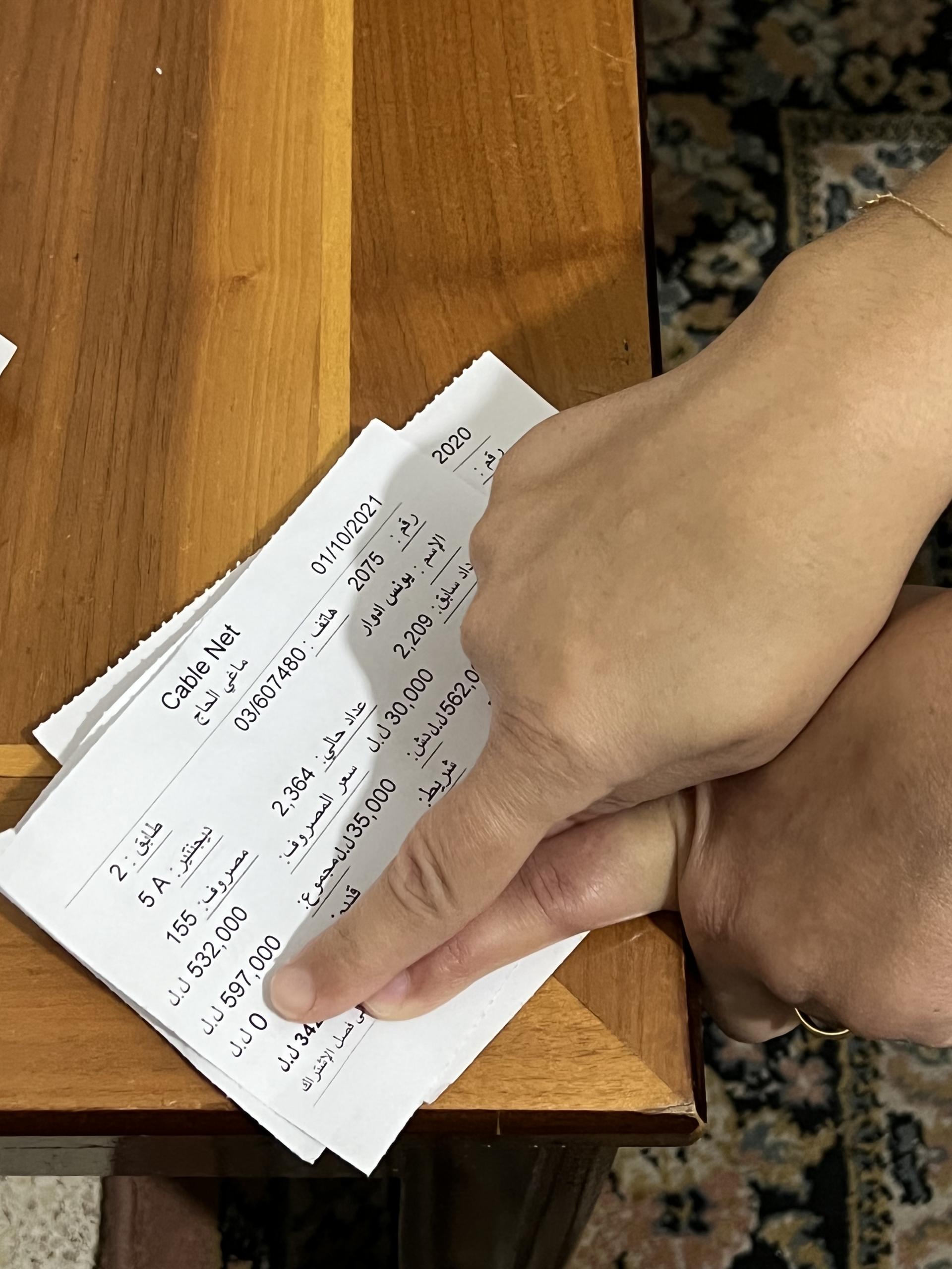 Beirut resident Diala Attieh Younes shows her generator bills. She paid about 600,000 lira last month. This is while she lost her job as a teacher at the beginning of the pandemic.