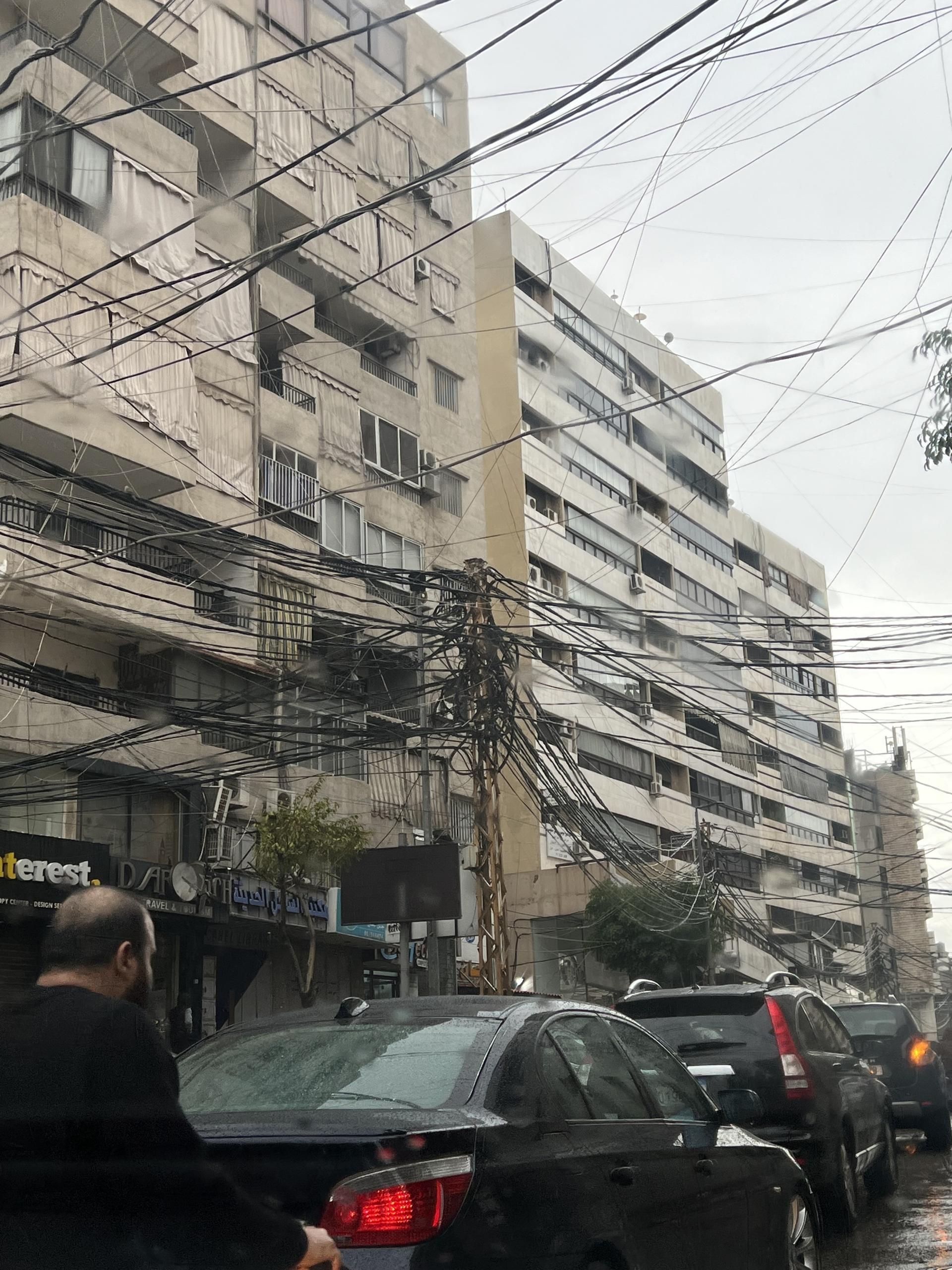 A web of electric cables runs through a neighborhood in Beirut. Government-provider electricity is only available for only a few hours a day.