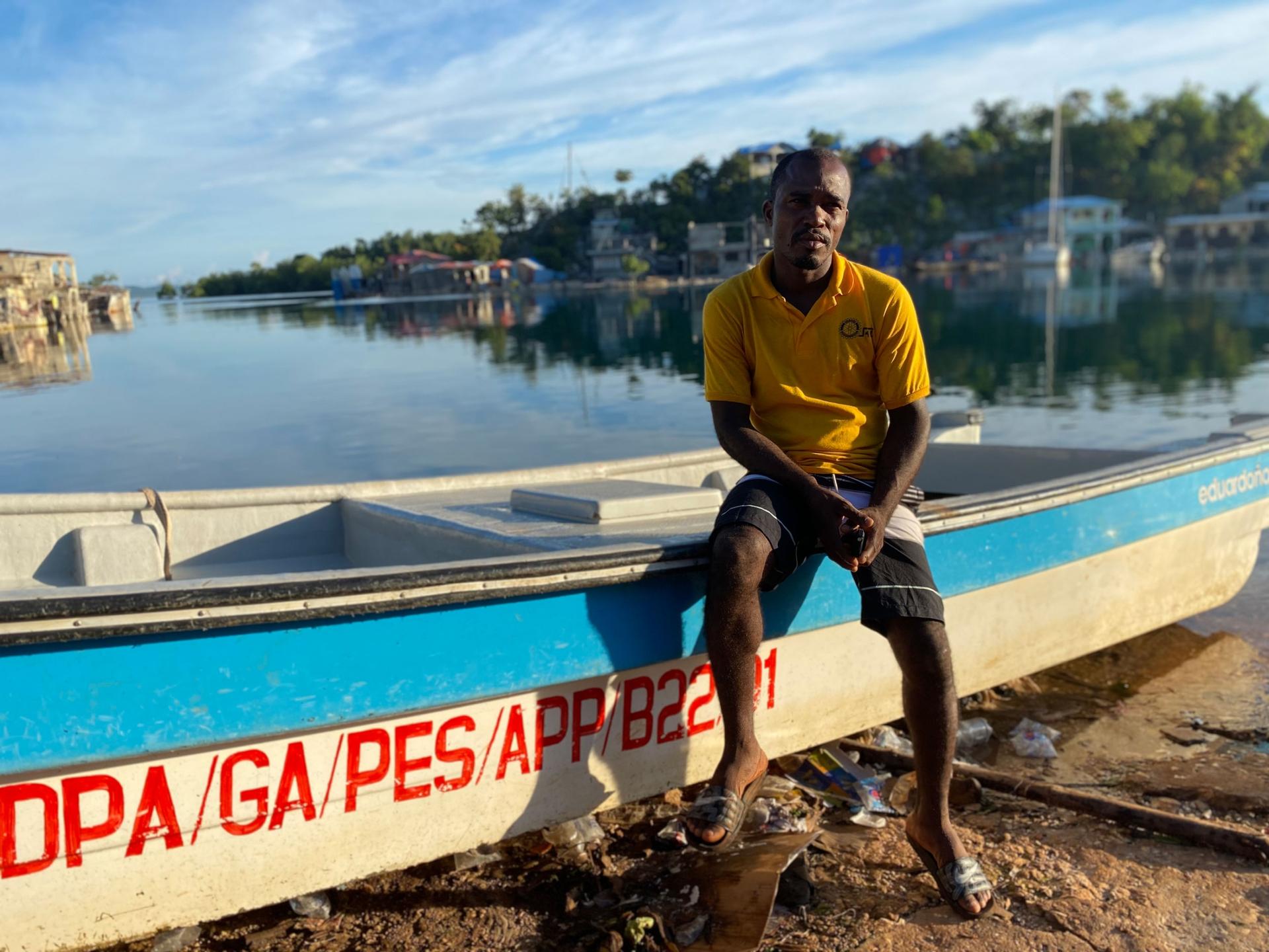 In Pestel, Haiti, on the country's southern peninsula, Jean-Robert Leger, poses in front of a boat that is a bit smaller than the one he has attempted in to sail to the United States. 
